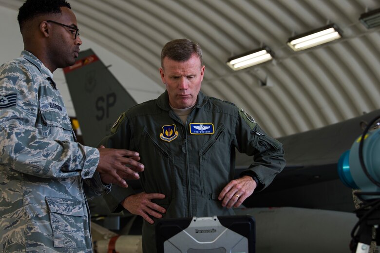 U.S. Air Force Gen. Tod D. Wolters, U.S. Air Forces in Europe-Air Forces Africa commander, speaks with Tech. Sgt. Adam Elerson, 52nd Aerospace Medicine Squadron Occupational Health NCO in charge, in a hardened aircraft shelter at Spangdahlem Air Base, Germany, Aug. 16, 2018. Elerson showed Wolters how bioenvironmental engineers track potential exposure for personnel who work in contaminated areas. Monitoring devices track individual and group exposures for long-term medical records. (U.S. Air Force photo by Airman 1st Class Valerie Seelye)