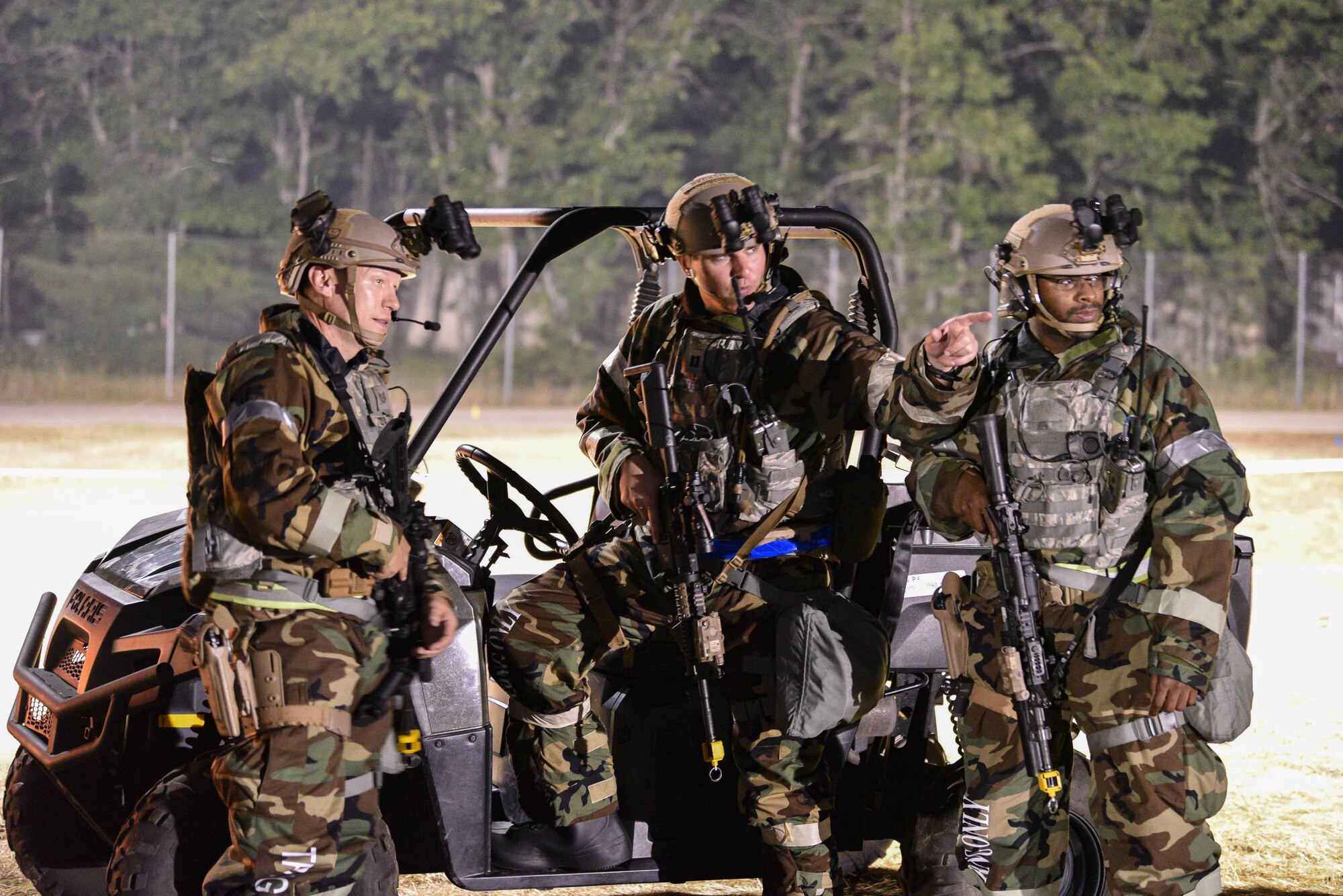 Capt. Frank Morgan (center) discusses force protection posture with Tech. Sgt. Craig Coale (left) and Staff Sgt. Aaron McGahee, all assigned to the Kentucky Air National Guard’s 123rd Contingency Response Group, during Operation Huron Thunder at the Alpena Combat Readiness Training Center in Alpena, Mich., July 23, 2018. The 123rd CRG worked in conjunction with the U.S. Army’s 690th Rapid Port Opening Element to operate a Joint Task Force-Port Opening during the exercise. The objective of the JTF-PO is to establish a complete air logistics hub and surface distribution network. (U.S. Air National Guard photo by Maj. Allison Stephens)