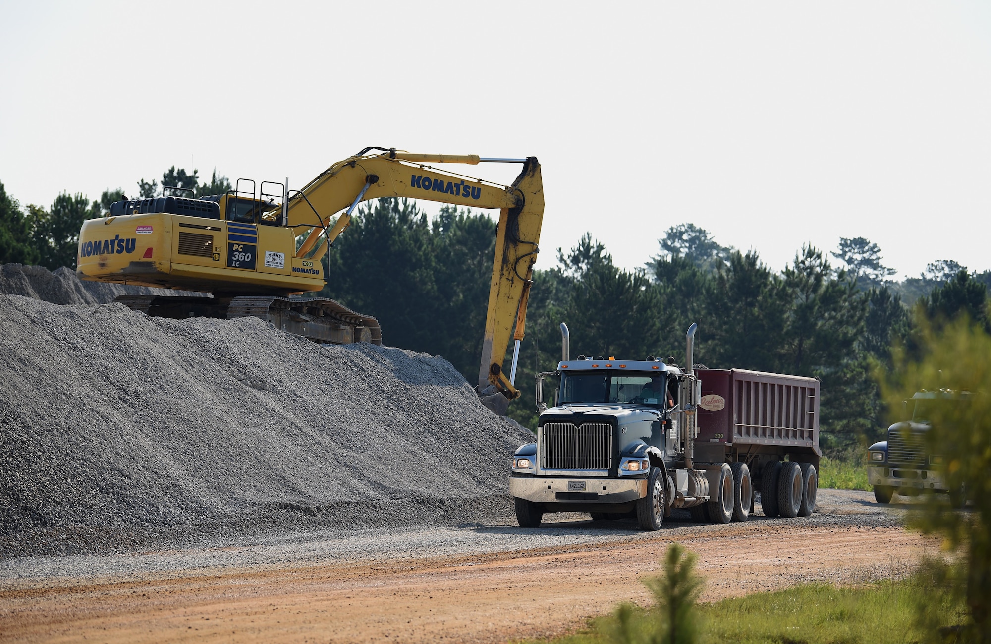A construction crew contracted by the 14th Flying Training Wing prepares to transport stones to the outside runway July 26, 2018, on Columbus Air Force Base, Mississippi. The last time this large of a runway project was completed was in 2005. (U.S. Air Force photo by Airman 1st Class Keith Holcomb)