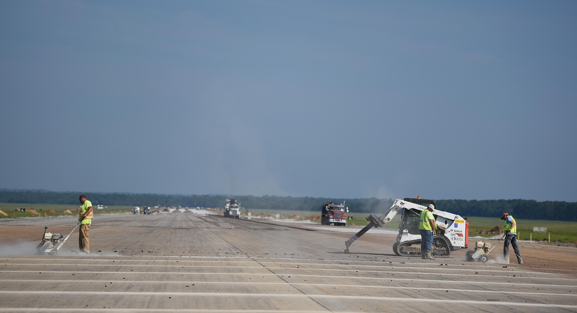 A construction crew contracted by the 14th Flying Training Wing separate slabs of concrete during reconstruction of the outside runway July 26, 2018, on Columbus Air Force Base, Mississippi. Hundreds of tons of stone has been used to resurface almost the entire outside runway. The project is one of many projects the 14th Civil Engineer Squadron is managing. (U.S. Air Force photo by Airman 1st Class Keith Holcomb)