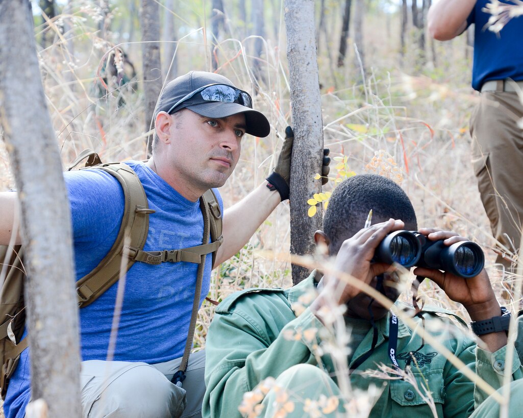 Army Staff Sgt. David Marcet, with the 404th Civil Affairs Battalion, assigned to Combined Joint Task Force Horn of Africa, provides guidance during a practical exercise in ground reconnaissance for Tanzania Wildlife Management Authority game wardens in Ngwala, Tanzania, July 24, 2018. Navy photo by Petty Officer 2nd Class Timothy M. Ahearn