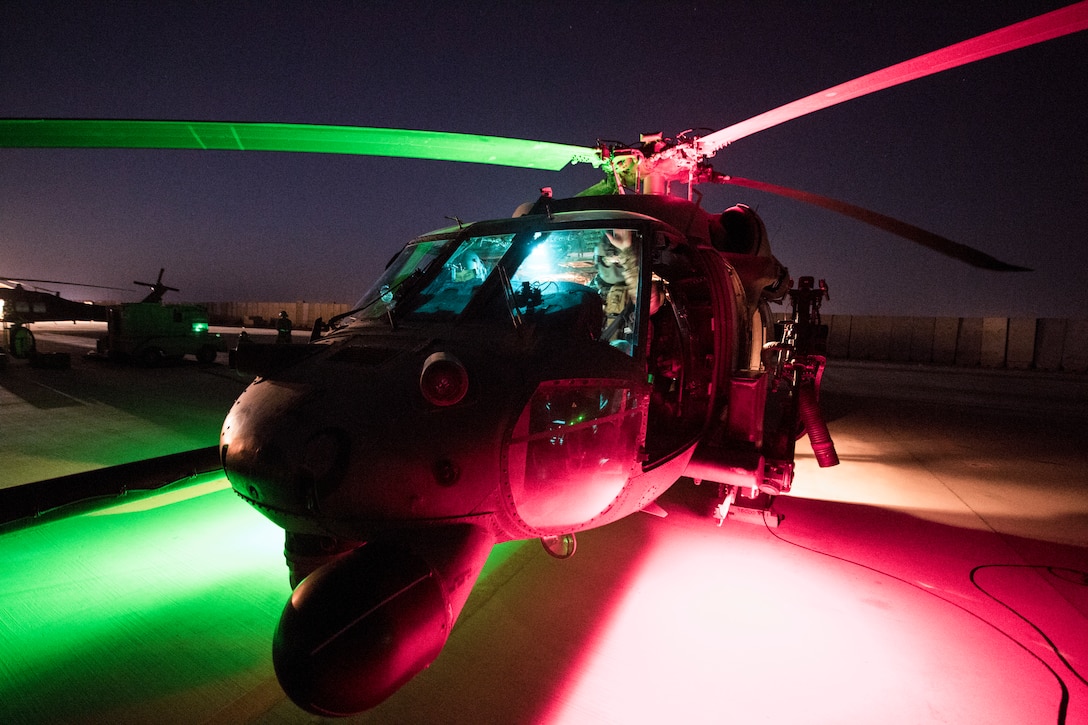 A U.S. Air Force HH-60G Pavehawk assigned to the 46th Expeditionary Rescue Squadron sits on the flight line as aircrew members pre flight the aircraft before a mission at an undisclosed location, Iraq, in support of Operation Inherent Resolve Aug. 8, 2018. The 46th ERQS provides combat search and rescue capabilities across the region in support of Operation Inherent Resolve. In conjunction with partner forces, Combined Joint Task Force - Operation Inherent Resolve defeats ISIS in designated areas of Iraq and Syria and sets conditions for follow-on operations to increase regional stability. (U.S. Air Force photo by Staff Sgt. Keith James)