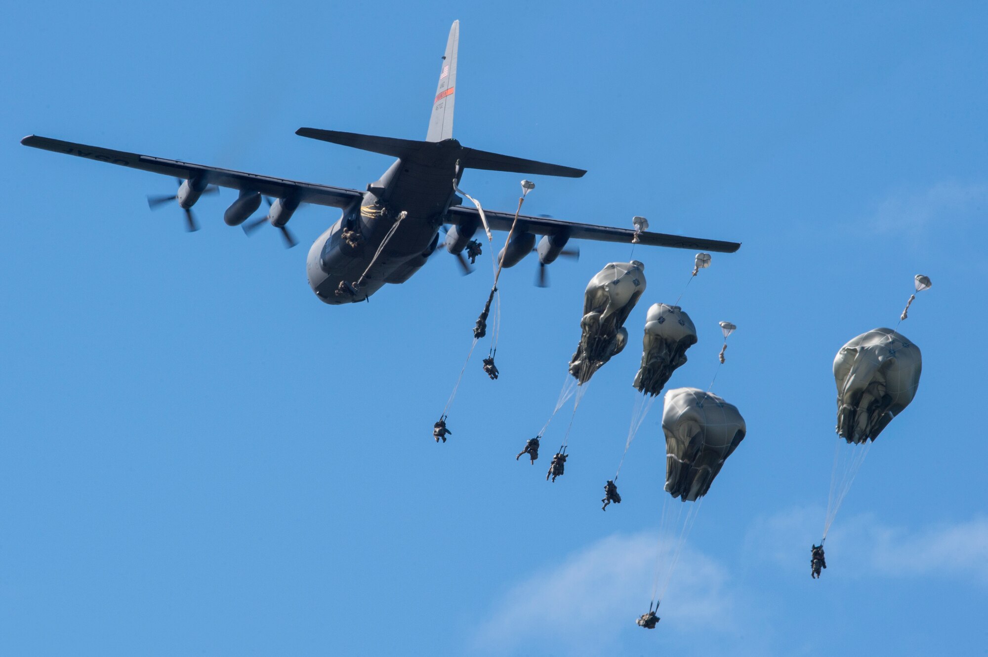 U.S. Army paratroopers assigned to the 4th Infantry Brigade Combat Team, 25th Infantry Division, U.S. Army Alaska, jump from an Illinois Air National Guard C-130 Hercules while conducting airborne training at Malemute Drop Zone, Joint Base Elmendorf-Richardson, Alaska, Aug. 9, 2018. The Soldiers of 4/25 belong to the only American airborne brigade in the Pacific and are trained to execute airborne maneuvers in extreme cold weather and high altitude environments in support of combat, partnership and disaster relief operations. Airmen from the 169th Airlift Squadron out of Peoria Air National Guard Base, Peoria, Ill., operated the C-130 Hercules. (U.S. Air Force photo by Alejandro Peña)
