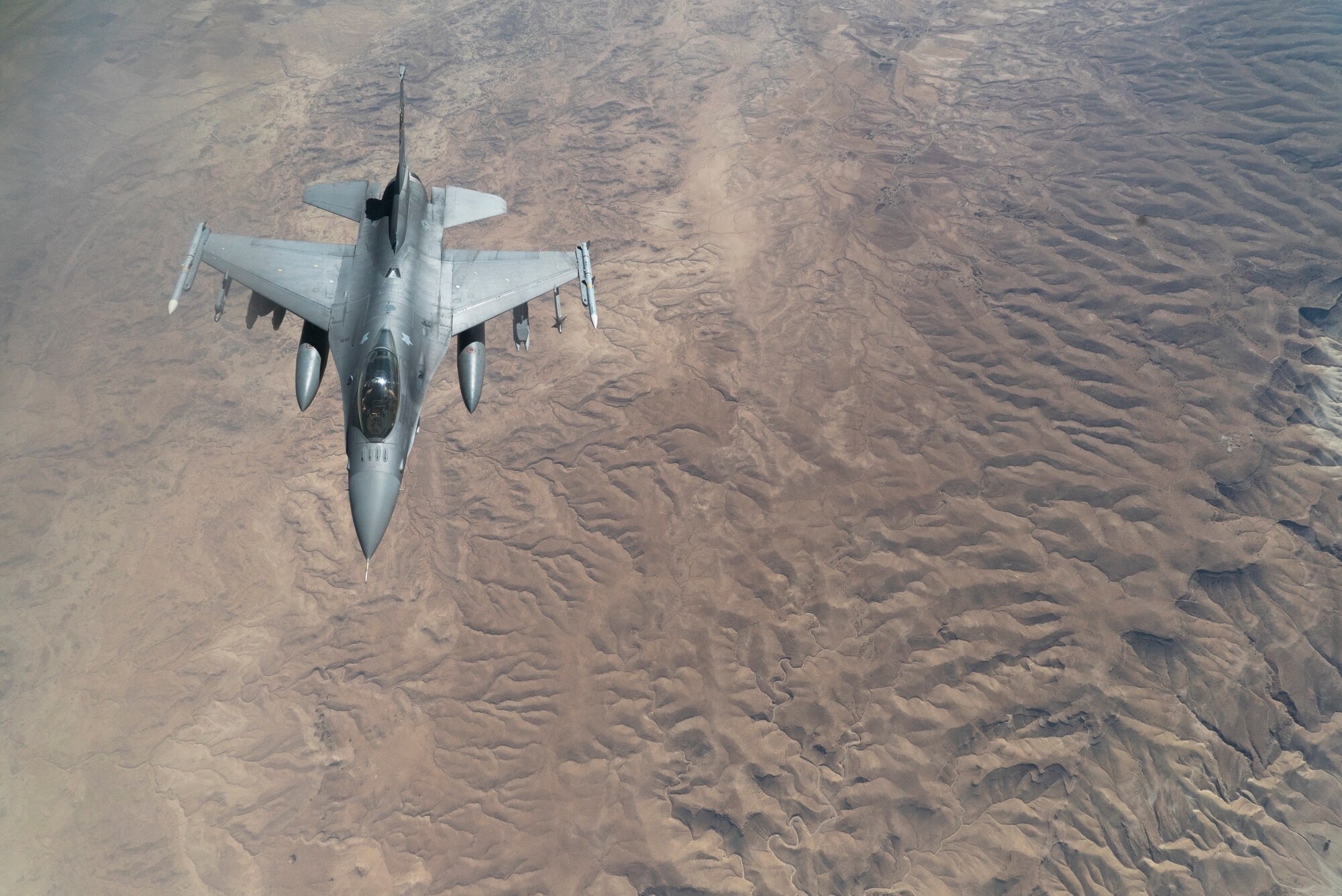 A U.S. Air Force F-16 Fighting Falcon descends away from a KC-135 Stratotanker after receiving fuel to continue its mission in support of Operation Inherent Resolve over Iraq, Aug. 11, 2018. In conjunction with partner forces, Combined Joint Task Force - Operation Inherent Resolve defeats ISIS in designated areas of Iraq and Syria and sets conditions for follow-on operations to increase regional stability. (U.S. Air Force photo by Master Sgt. Burt Traynor)
