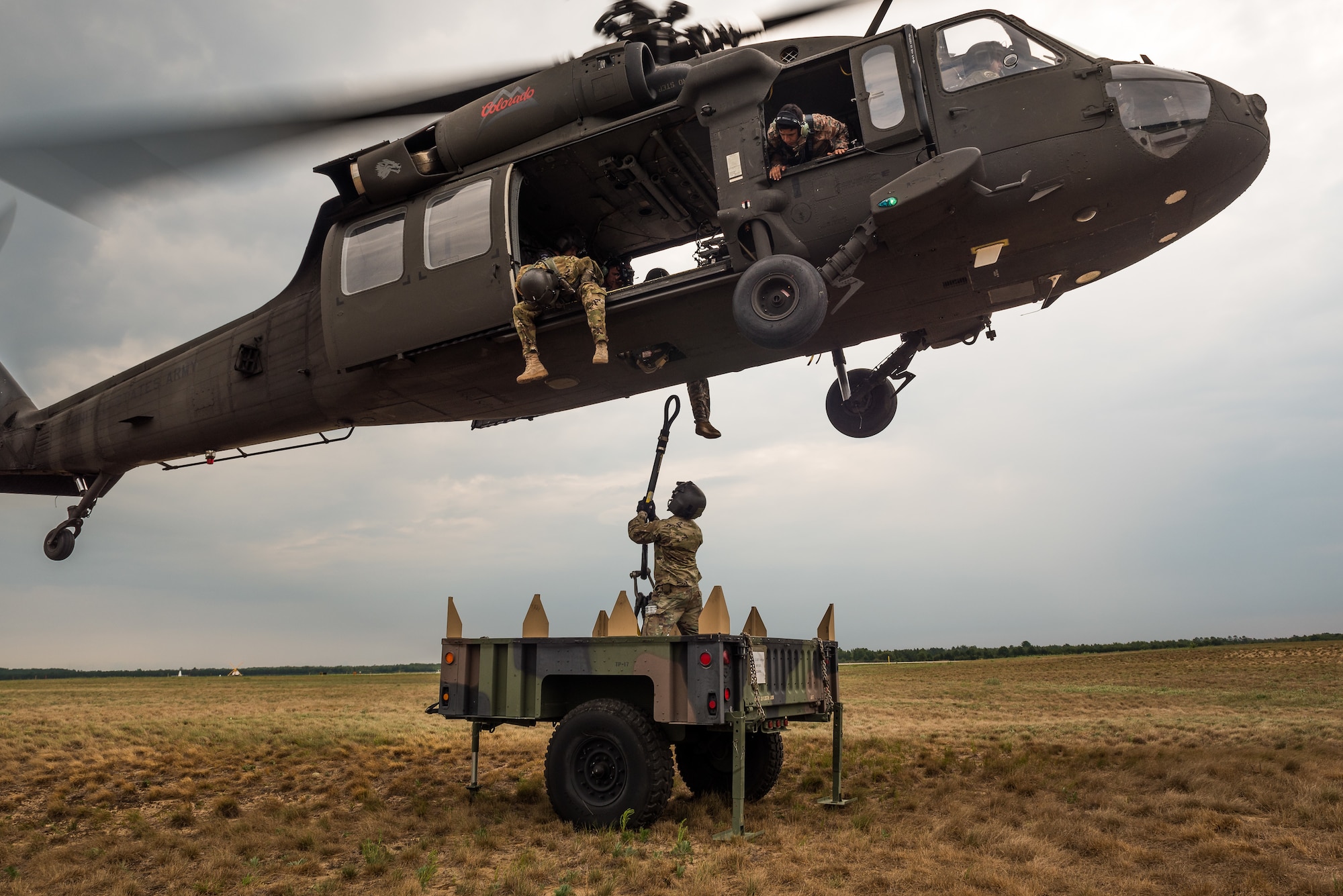 U.S. Army Spc. Dominic Mondragon, a UH-60 helicopter repairer with Company A, 2nd Battalion, 135th Aviation Regiment, Colorado Army National Guard, attaches a sling load to a UH-60 Black Hawk helicopter while training with members of the Royal Jordanian Army during Northern Strike 18 in Alpena, Mich., Aug. 11, 2018. Northern Strike 18 is a National Guard Bureau-sponsored joint-force exercise that unites U.S. Department of Defense and multinational coalition service members to exercise proficiency in mission command, air, sea and ground maneuver integration. (U.S. Air National Guard photo by Tech. Sgt. Lealan Buehrer)