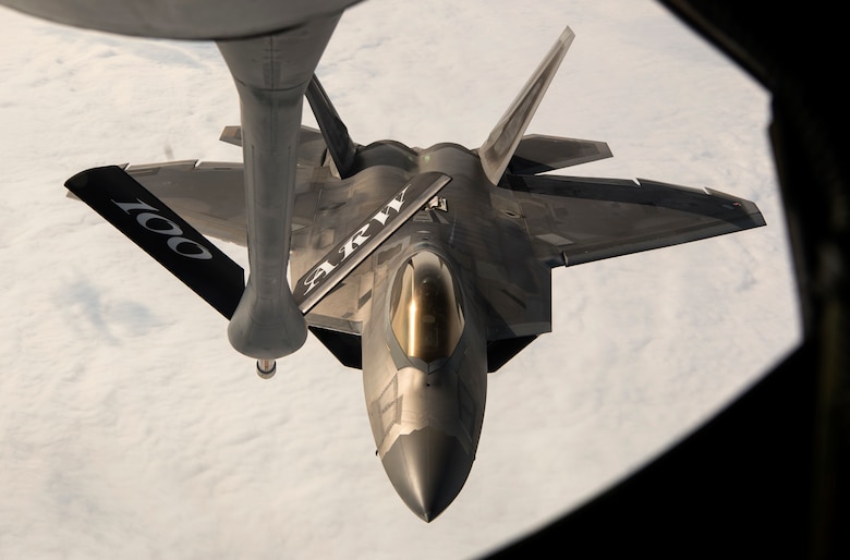 A U.S. Air Force F-22 Raptor from the 95th Fighter Squadron, Tyndall Air Force Base, Fla., receives fuel from a U.S Air Force Boeing KC-135 Stratotanker assigned to the 100th Air Refueling Wing, Royal Air Force Mildenhall, England, above Norway, Aug. 15, 2018. The F-22s practiced refueling and trained with Royal Norwegian air force F-35A Lightning II aircraft during a forward deployment to Orland Air Base, Norway. (U.S. Air Force photo by Senior Airman Preston Cherry)