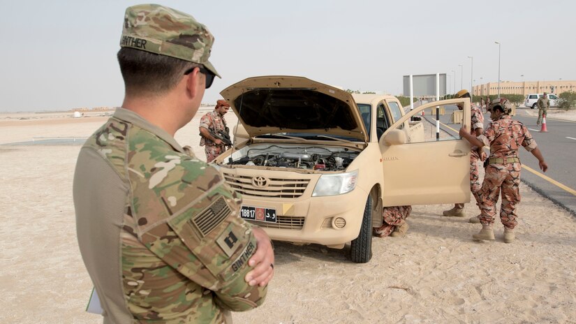 U.S. Army Capt. Ken Ginther, the officer in charge assigned to the 157th Military Engagement Team, Wisconsin Army National Guard, attached to U.S. Army Central, observes soldiers from the Royal Army of Oman's Border Guard Brigade performing a vehicle search as part of a practical exercise in which soldiers from each country demonstrated their preferred method of operating a vehicle control point in Haima, Oman, Aug. 8, 2018. The collaborative exercise increased interoperability between the U.S. Army and Omani Army by creating an opportunity for soldiers from each country to share best practices in border security.