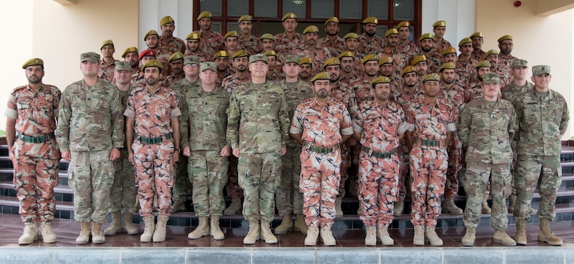 U.S. Army Soldiers from U.S. Army Central and soldiers from the Royal Army of Oman's Border Guard Brigade pose for a group photo to commemorate the end of a successful engagement between the two military forces in Haima, Oman, Aug. 9, 2018. Soldiers from the 157th MET, and Oman's Border Guard Brigade spent the week sharing border security strategies and building long lasting relationships between the two forces.