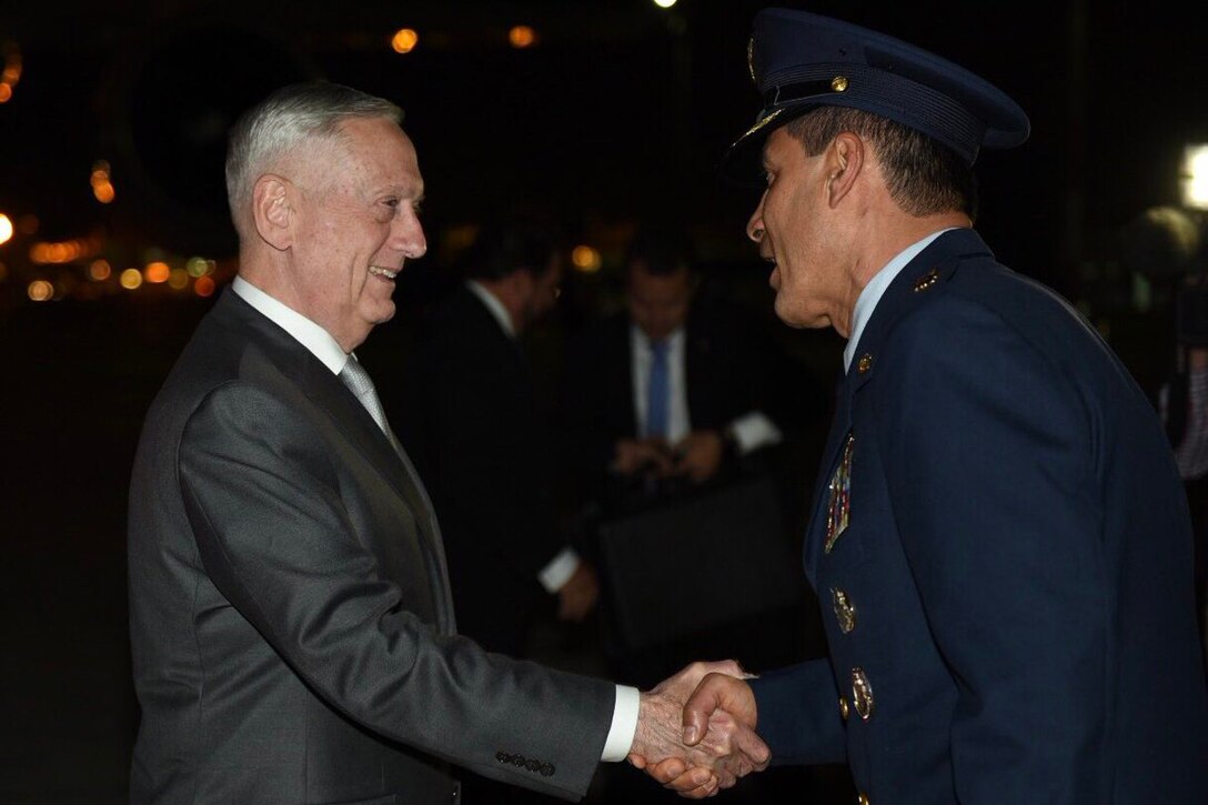 Defense Secretary James N. Mattis shakes hands with a Colombian military official.