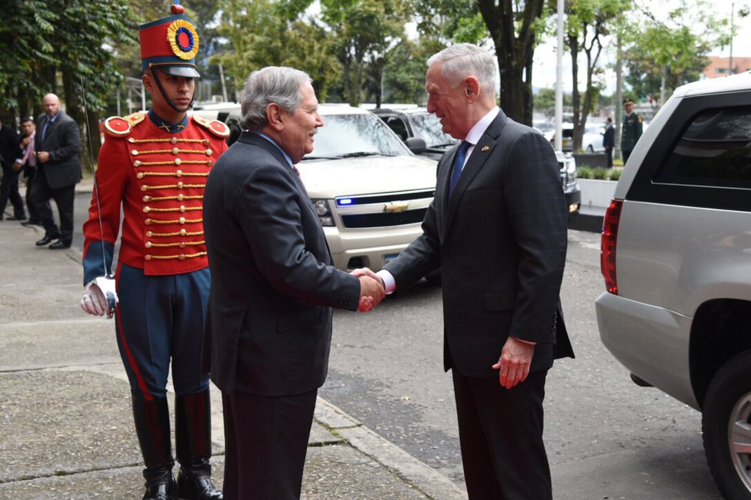 Defense Secretary James N. Mattis shakes hands with Colombian Defense Minister Guillermo Botero.
