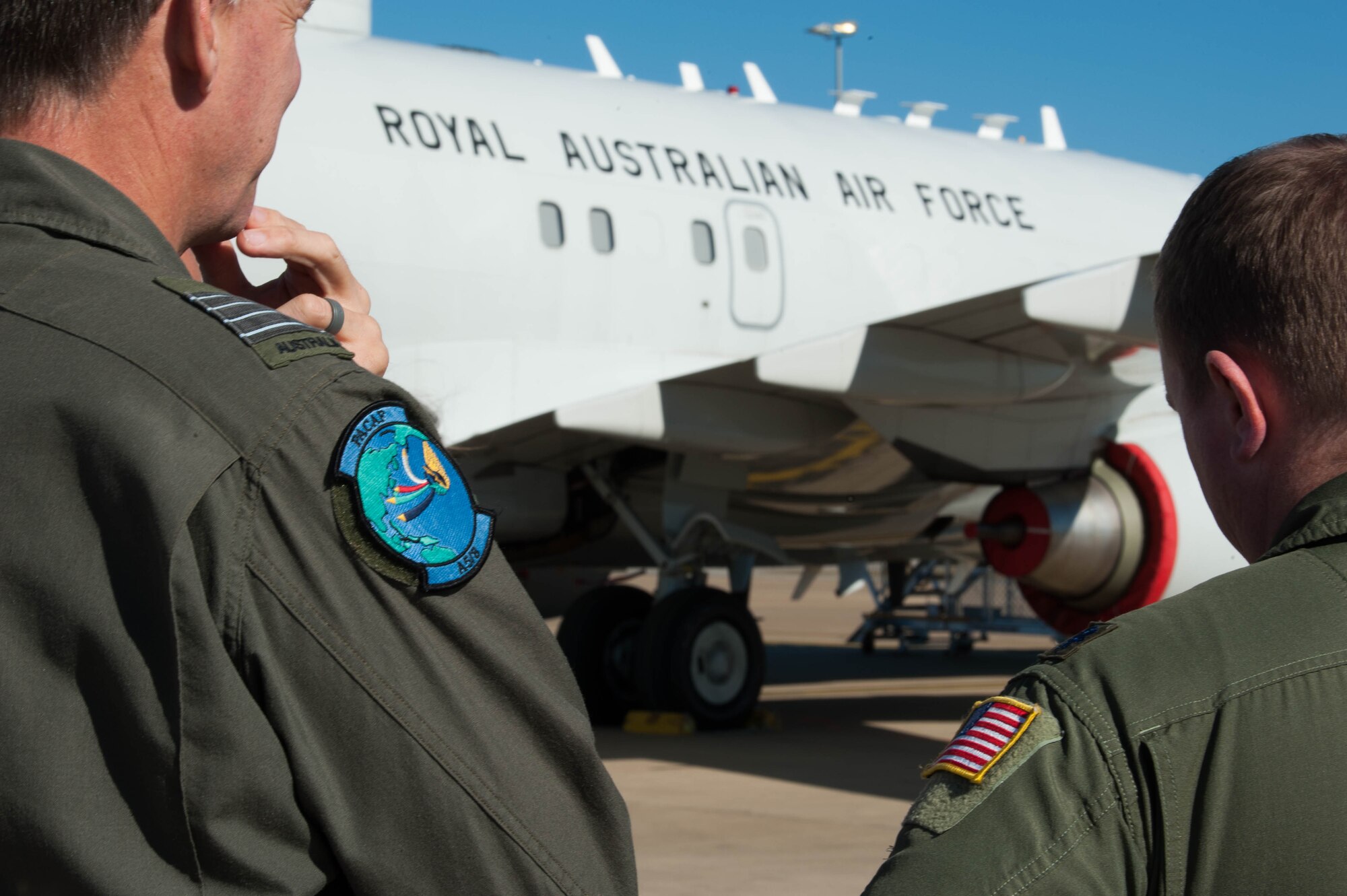 Group Capt. Stewart Dowrie, Royal Australian Air Force (RAAF) Liaison Officer to Pacific Air Forces, and Lt. Col. Wesley Sides, Air Force Programs, Office Defense Cooperation/Security Cooperation Organization, U.S. Embassy Canberra, Australia, take a tour of an E-7A Wedgetail at Royal Australian Air Force Williamtown, Australia, Aug. 9, 2018. Based out of Williamtown, the RAAF’s six E-7As provide an advanced air battle management capability.   (U.S. Air Force photo by Staff Sgt. Hailey Haux)