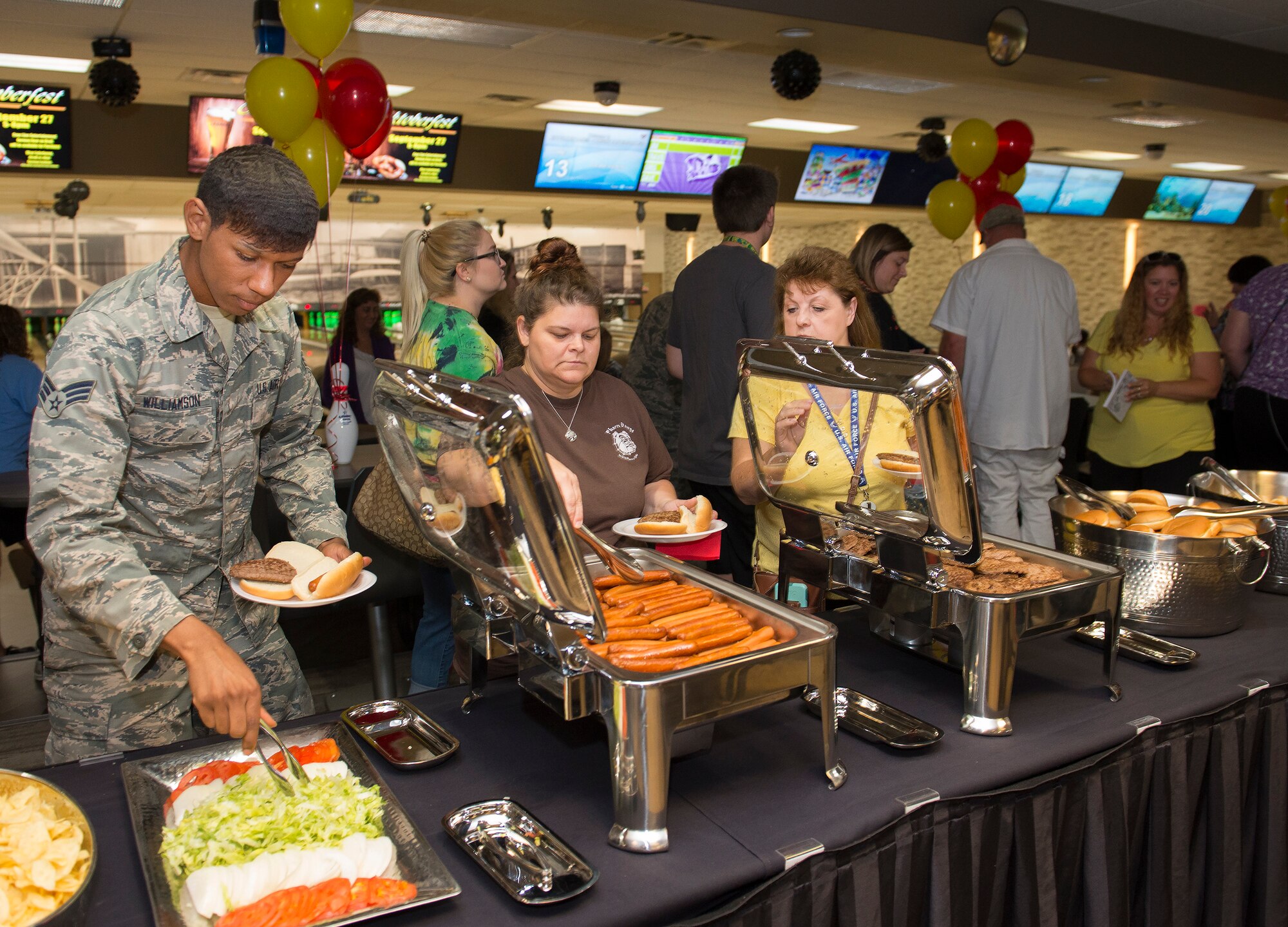 Patrons of the Wright-Patterson Air Force Base, Ohio, Bowling Center partake in free hamburgers and hot dogs Aug. 13, 2018, as part of the center’s grand reopening celebration.