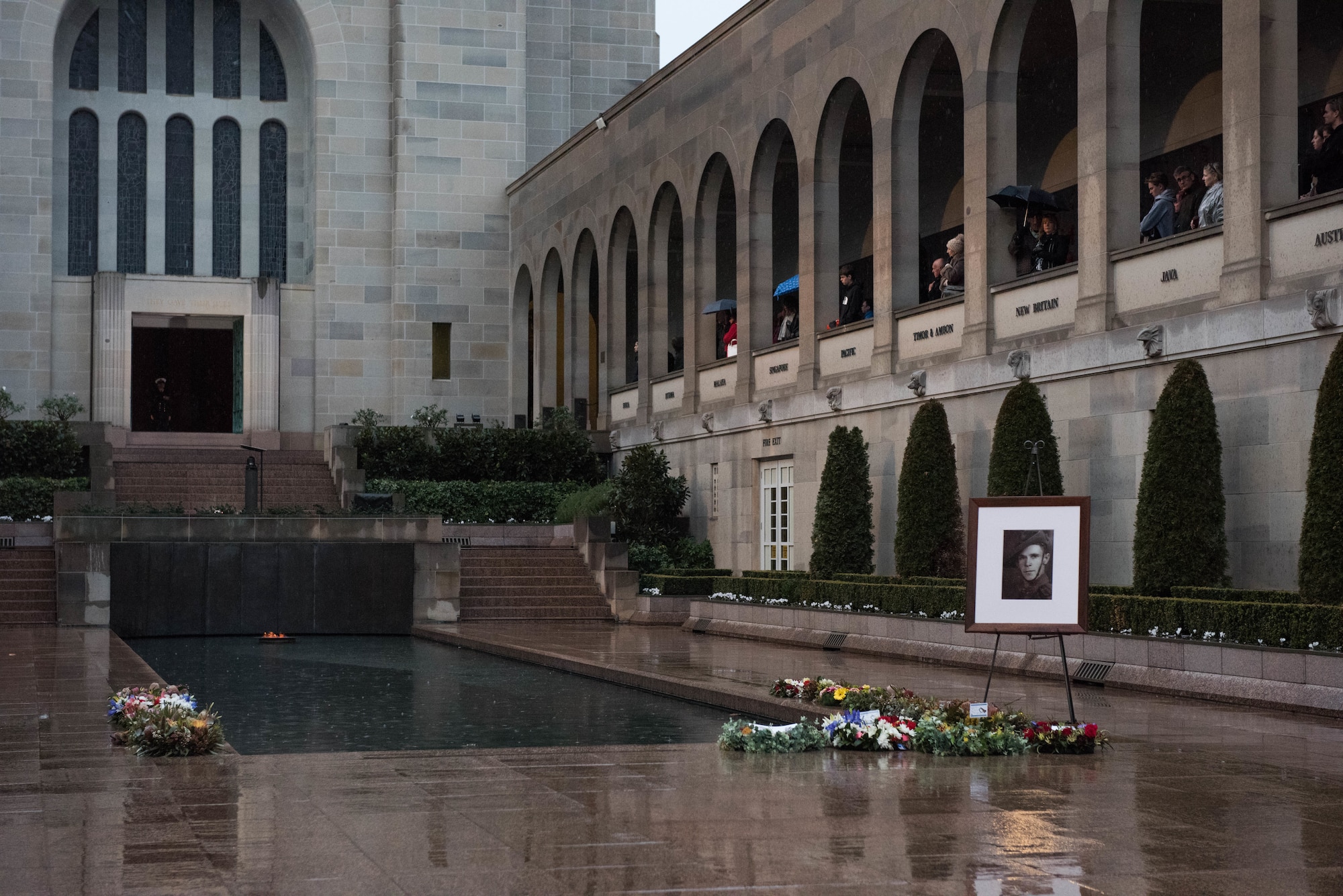 A portrait of Pvt. Robert Young of the Australian Army sits at the base of the pool of remembrance at the Australia War Memorial in Canberra, Australia, Aug. 11, 2018. Young fought in World War II and died March 21, 1944. Gen. CQ Brown, Jr., Pacific Air Forces commander, participated in Young’s “Last Post” ceremony, honoring his service and sacrifice, further demonstrating the strength of the U.S.-Australian alliance.   (U.S. Air Force photo by Staff Sgt. Hailey Haux)
