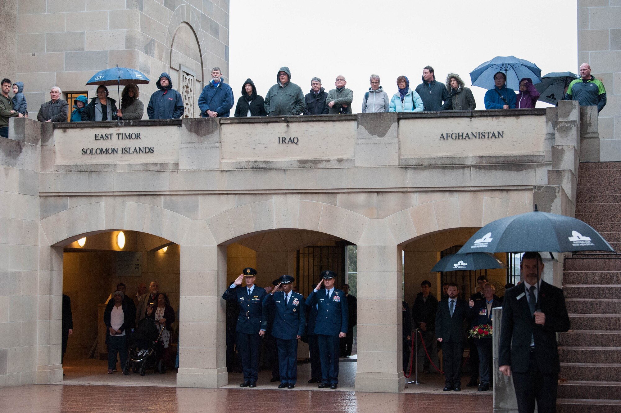 Group Captain Stewart Dowrie (left), Royal Australian Air Force liaison officer to Pacific Air Forces, Gen. CQ Brown, Jr., Pacific Air Forces commander, and Col. David Shoemaker, COMPACAF Executive Officer, salute during “Last Post” ceremony at the Australia War Memorial in Canberra, Australia, Aug. 11, 2018. The ceremony was held to honor Pvt. Robert Young of the Australian Army, who fought in World War II and died March 21, 1944. (U.S. Air Force photo by Staff Sgt. Hailey Haux)