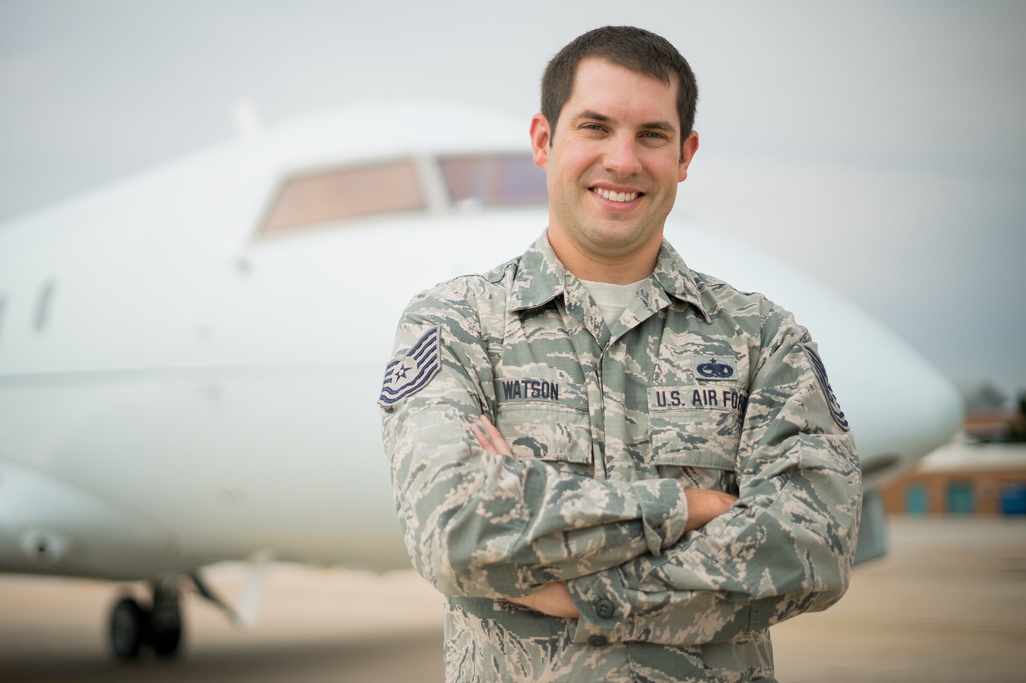 Tech. Sgt. Brian Watson, 1st Aviation Standards Flight aircraft mechanic, poses for a photo near a Bombardier Challenger 601 July 23, 2018, at Will Rogers World Airport, Okla.