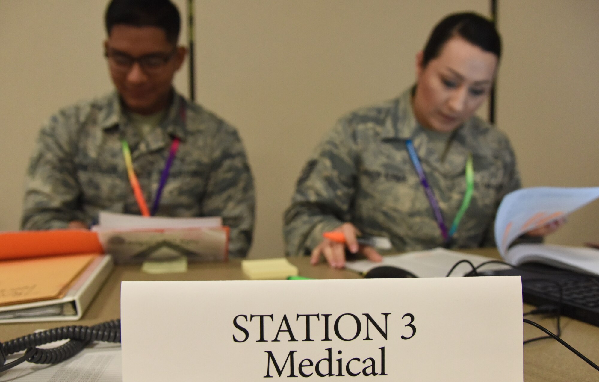U.S. Air Force Airman 1st Class Aldair Concepcion, 81st Aerospace Medicine Squadron public health technician, and Tech. Sgt. Jenny Johnson-Newman, 81st AMDS force health management NCO in charge, assist Keesler Airmen at the medical station during a deployment exercise at the Roberts Consolidated Aircraft Maintenance Facility on Keesler Air Force Base, Mississippi, Aug. 16, 2018. The exercise scenario tested the mission readiness of Team Keesler for deployments. (U.S. Air Force photo by Kemberly Groue)