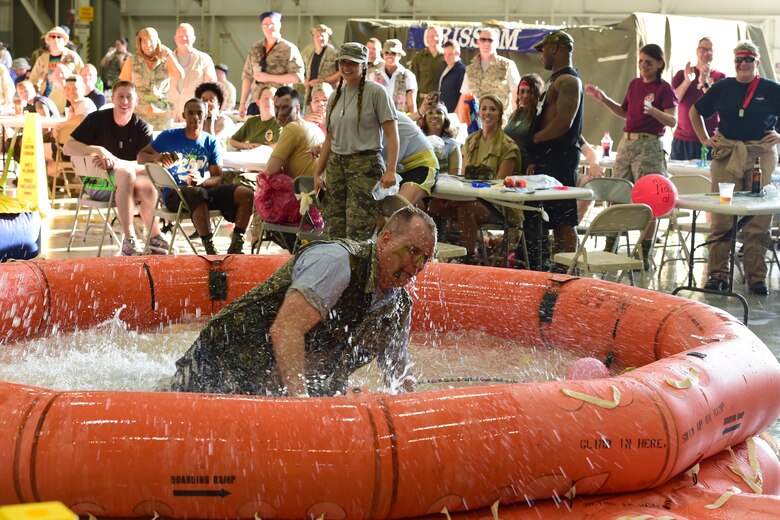 Tech. Sgt. Daniel Huff, 434th Force Support Squadron readiness technician, emerges from a pool of water at the end of the obstacle course during a combat dining in at Grissom Air Reserve Base, Ind., Aug. 18, 2018. Grissom held its first combat dining in since 2007, where Airmen faced several fun challenges and were encouraged to show off their homemade uniforms. (U.S. Air Force Photo / Staff Sgt. Christopher Massey)
