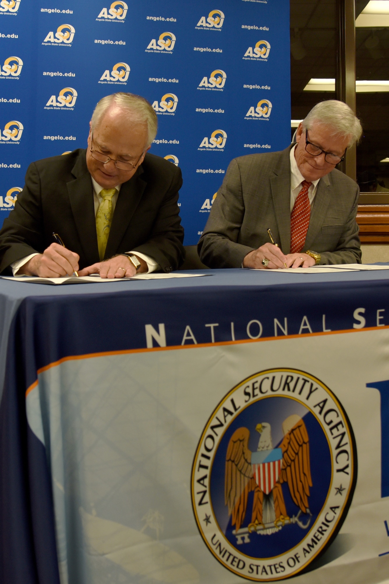Angelo State University president, Dr. Brian May, and National Cryptologic School commandant, Dr. Leonard Reinsfelder, sign the ASU and NCS Articulation Agreement during a signing ceremony at ASU’s Houston Harte University Center in San Angelo, Texas, Aug. 16, 2018. During the ceremony, both men mentioned the importance of having better educated and qualified individuals working in the intelligence field. (U.S. Air Force photo by Staff Sgt. Joshua Edwards/Released)