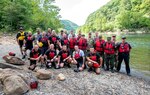 Senior Enlisted Advisors from the Peruvian Army, Navy and Air Force, pose for a photo with the West Virginia National Guard’s swift water rescue boat Aug. 14, 2018, at Fayette Station, West Virginia. The Peruvian delegation viewed training being conducted by the WVSWRT on the New River and how they respond to swift water emergencies