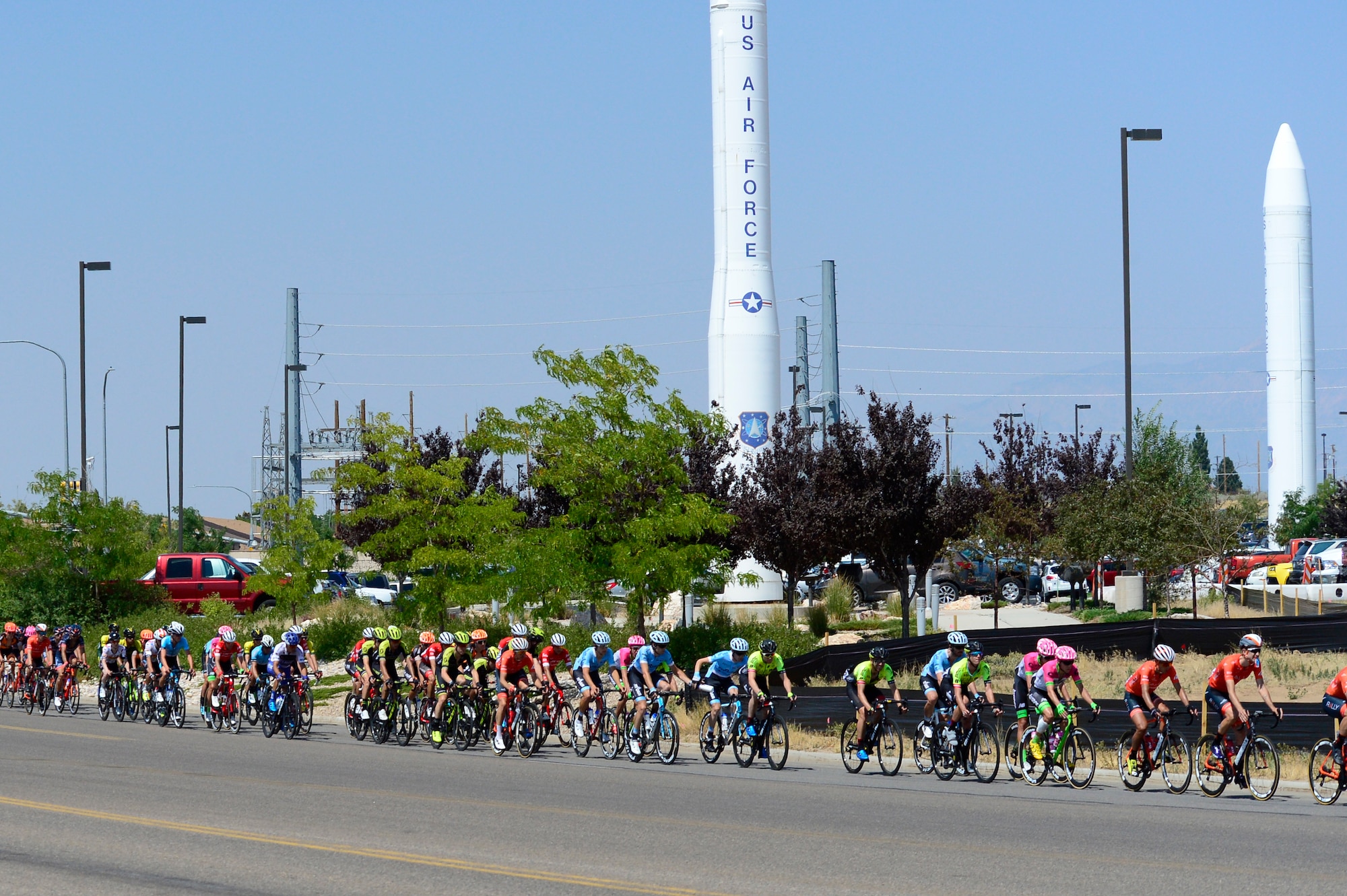 The peloton passes by a Minuteman III static display during stage 3 of the 2018 Tour of Utah road race Aug. 9, 2018, at Hill Air Force Base, Utah. The Tour of Utah is one of the top professional cycling events in the country and showcases some of the world’s best teams and cyclists. Stage 3 of the multiday race took riders on a 116-mile route from Antelope Island to Layton and included a loop through the installation. (U.S. Air Force photo by David Perry)