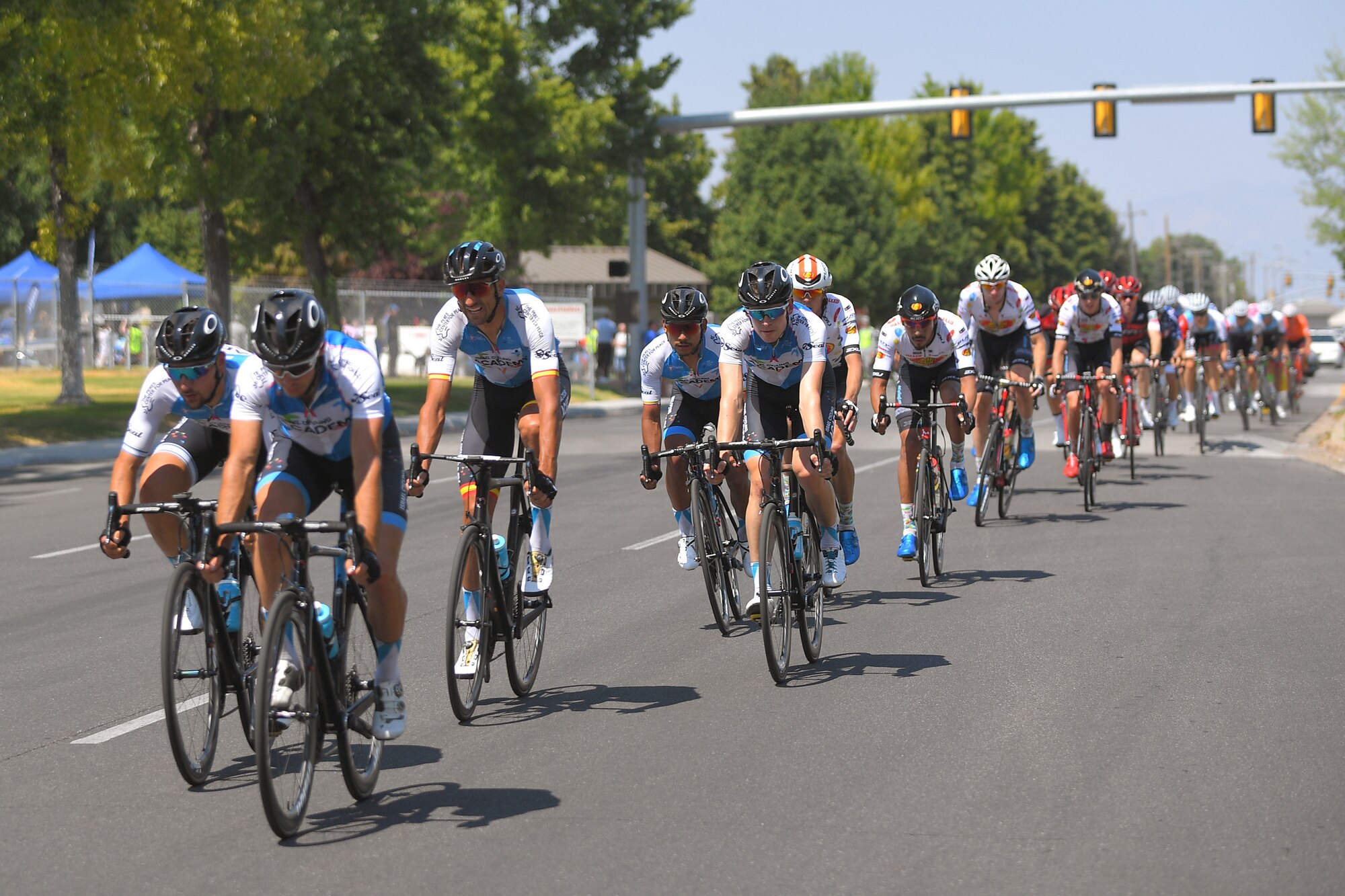 The peloton exits the base during stage 3 of the 2018 Tour of Utah road race Aug. 9, 2018, at Hill Air Force Base, Utah. The Tour of Utah is one of the top professional cycling events in the country and showcases some of the world’s best teams and cyclists. Stage 3 of the multiday race took riders on a 116-mile route from Antelope Island to Layton and included a loop through the installation. (U.S. Air Force photo by Todd Cromar)