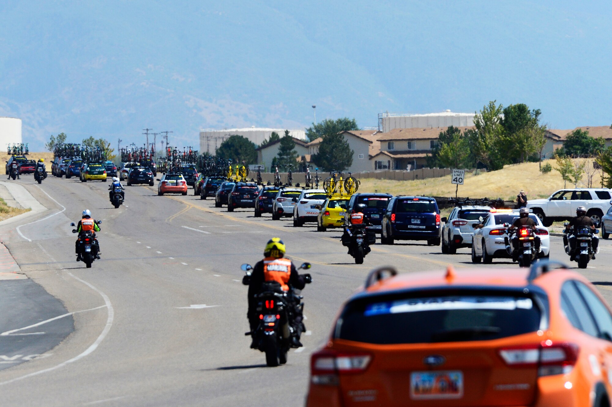Support vehicles follow riders during stage 3 of the 2018 Tour of Utah road race Aug. 9, 2018, at Hill Air Force Base, Utah. The Tour of Utah is one of the top professional cycling events in the country and showcases some of the world’s best teams and cyclists. Stage 3 of the multiday race took riders on a 116-mile route from Antelope Island to Layton and included a loop through the installation. (U.S. Air Force photo by David Perry)