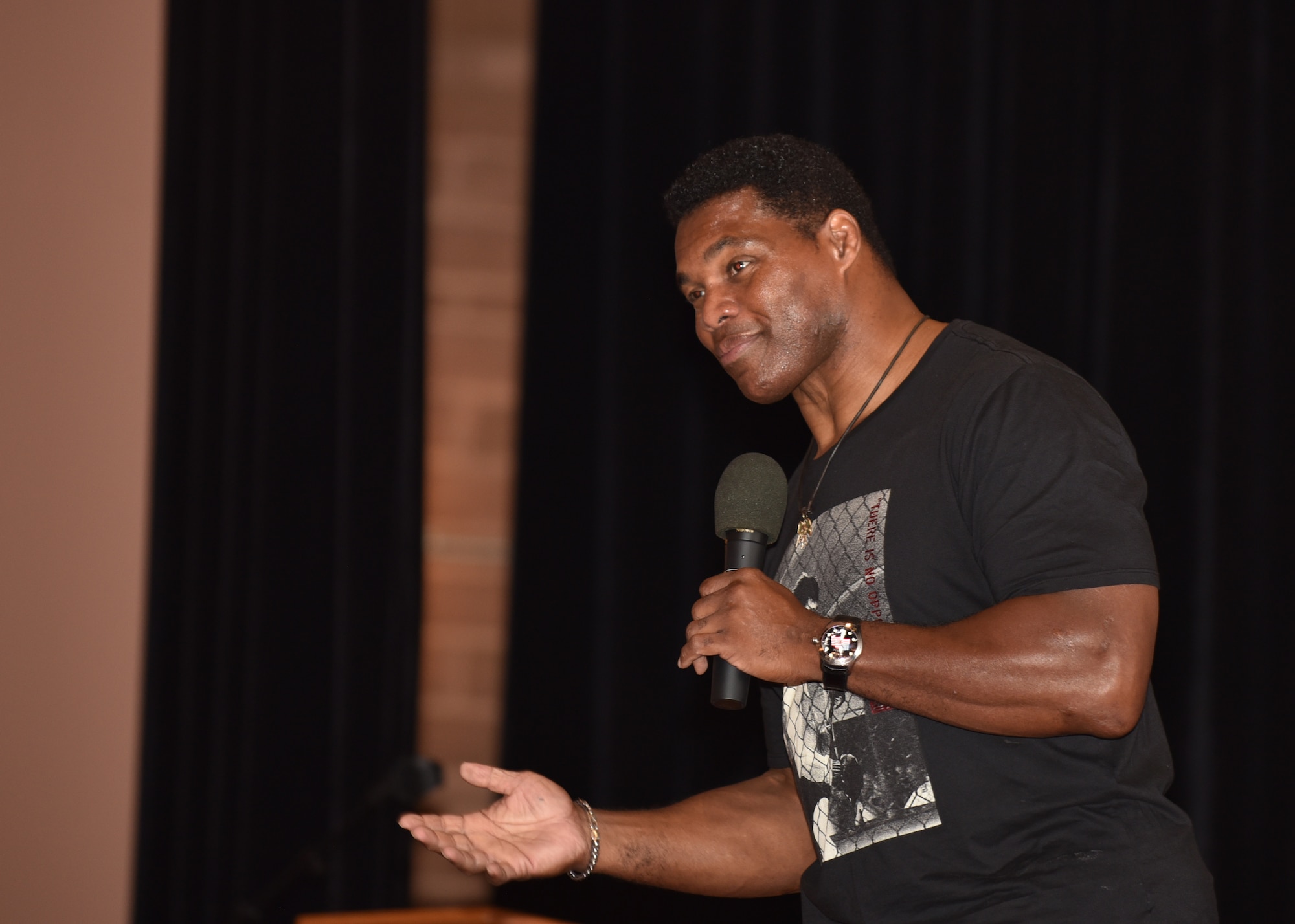 Herschel Walker, former professional football player, speaks to 90th Missile Wing Airmen Aug. 14, 2018, during his visit to F.E. Warren Air Force Base, Wyo. Walker’s speech encouraged Airmen to be resilient and never give up even through life’s toughest times. (U.S. Air Force photo by Airman 1st Class Braydon Williams)