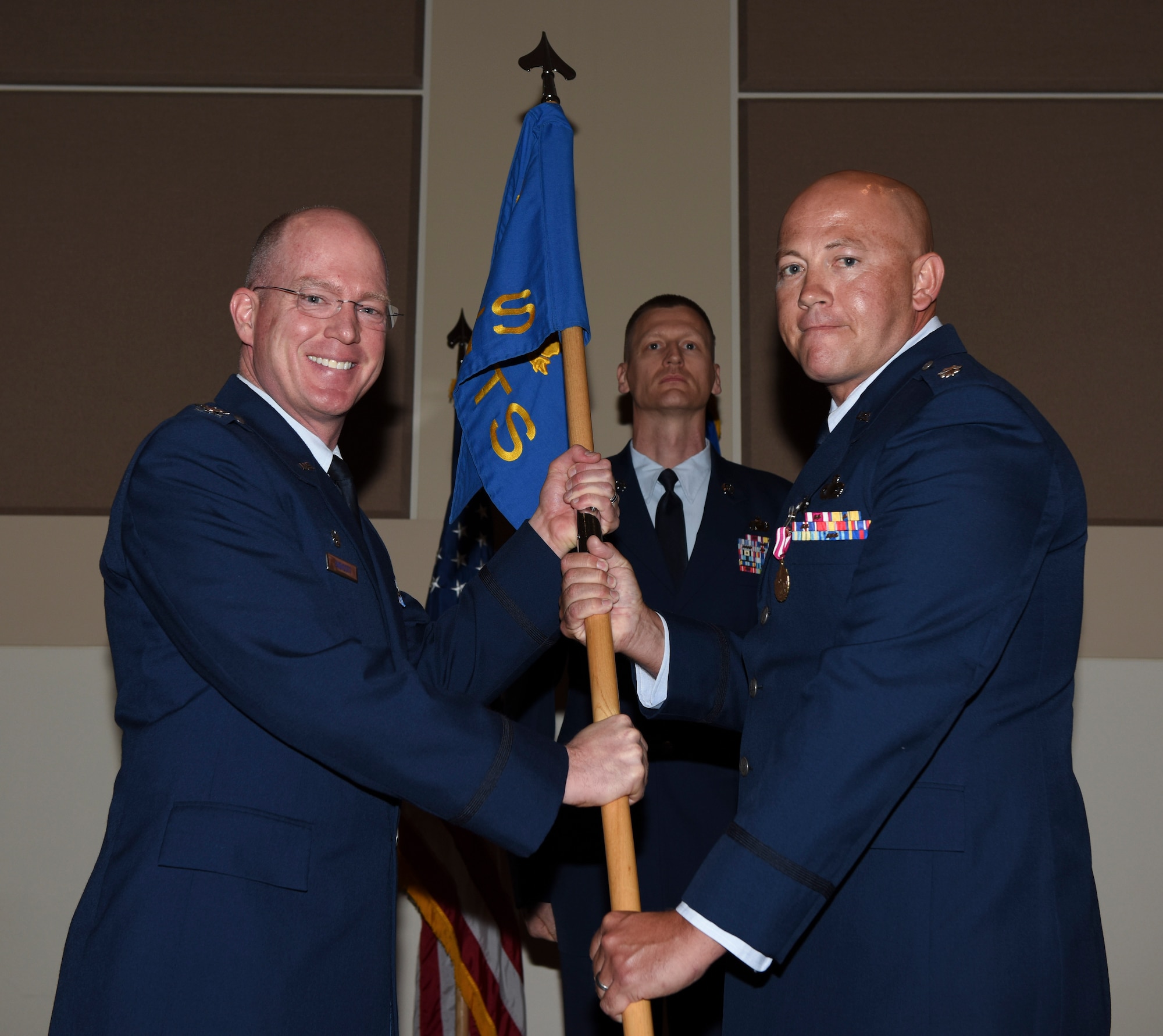 Col. Troy Endicott, 460th Space Wing commander, receives the guidon from Lt Col. Christopher Humphrey, 460th Comptroller Squadron outgoing commander, July 19, 2018, on Buckley Air Force Base, Colorado. The exchanging of the guidon symbolizes the official change of command. (U.S. Air Force photo by Airman 1st Class Michael D. Mathews)