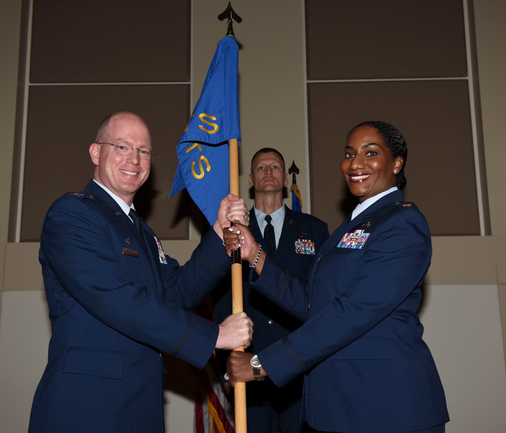 Col. Troy Endicott, 460th Space Wing commander, passes the guidon to Lt. Col. Shannon McDougald, 460th Comptroller Squadron commander, July 19, 2018, on Buckley Air Force Base, Colorado. The exchanging of the guidon symbolizes the official change of command. (U.S. Air Force photo by Airman 1st Class Michael D. Mathews)