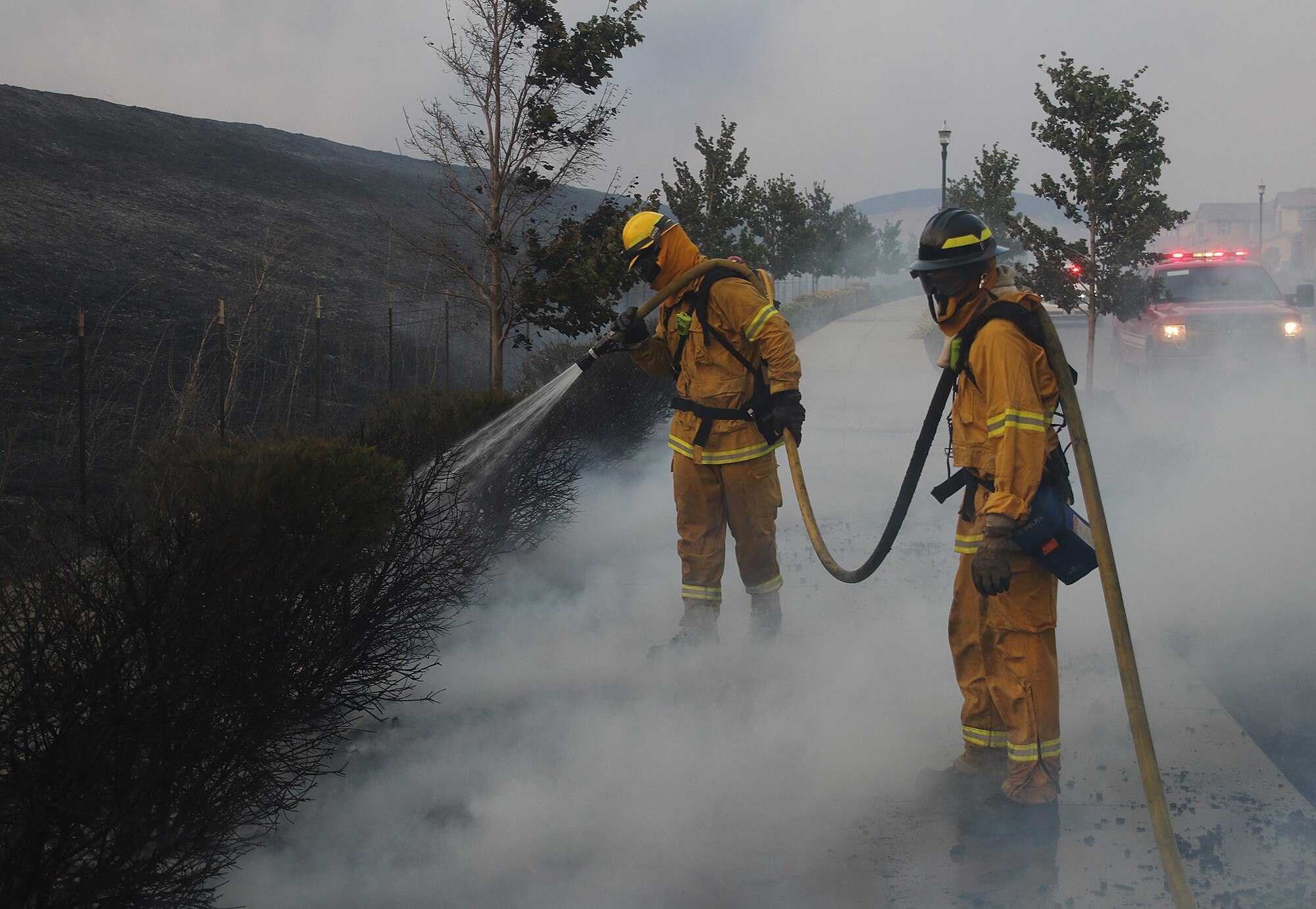 Firefighters from Travis Air Force Base, Calif., work to prevent the spread of the Nelson Fire in Vacaville, Calif., Aug. 10. Travis dispatched 12 firefighters, two fire engines and one water tanker to support firefighting efforts. The fire scorched 2,162 acres before it was extinguished. (Courtesy photo by Matthew Henderson) Facebook.com/onfirephotos