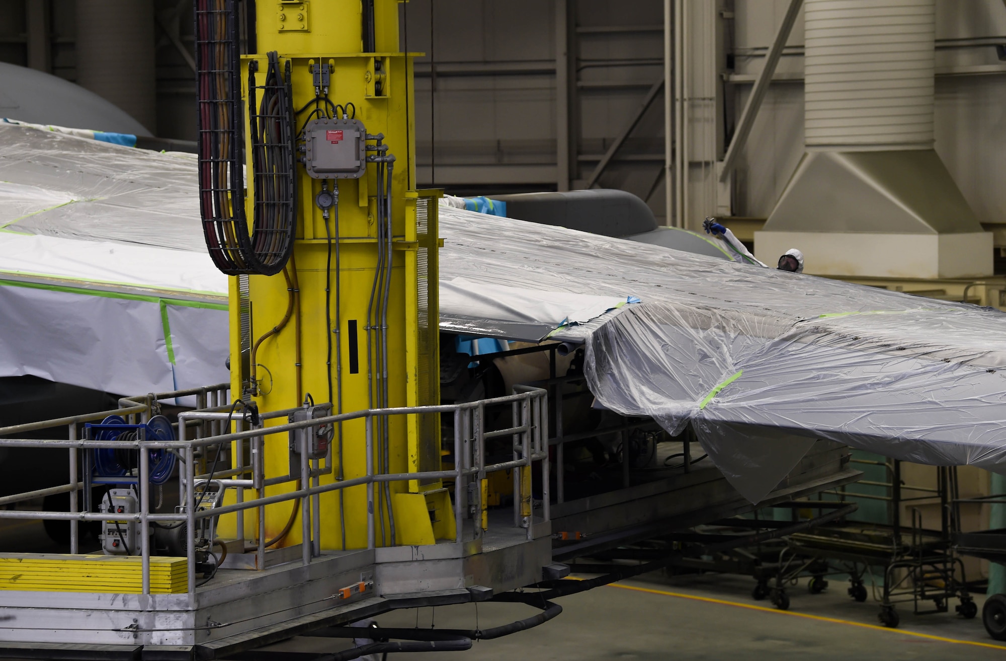 Staff Sgt. Cody Lange, 60th Maintenance Squadron aircraft structural maintenance technician, prepares to spray paint onto the wing of a C-17 Globemaster III from Travis Air Force Base, Calif., Aug. 6, 2018, at Joint Base Lewis-McChord, Wash. Lange, among other Travis Airmen, flew their C-17 to McChord Field to use the paint barn at the base. (U.S. Air Force photo by Senior Airman Tryphena Mayhugh)