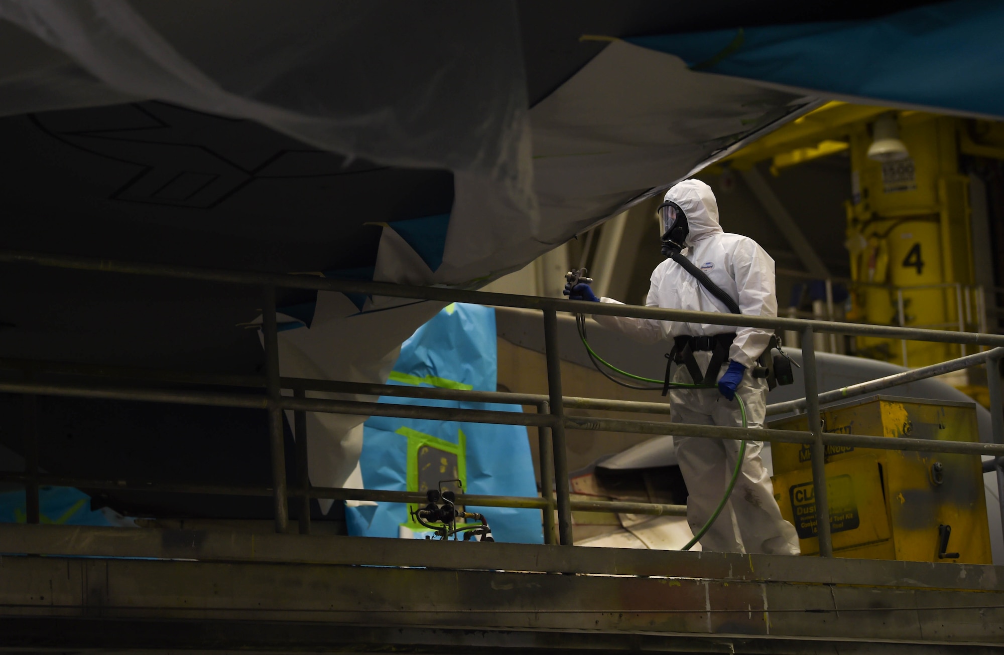 Staff Sgt. Cody Lange, 60th Maintenance Squadron aircraft structural maintenance technician, prepares to spray paint onto the wing of a C-17 Globemaster III from Travis Air Force Base, Calif., Aug. 6, 2018, at Joint Base Lewis-McChord, Wash. California does not allow spraying paint, which is a more effective way for bonding the paint to the metal versus rolling it on, so Travis Airmen brought their C-17 to McChord where there are no such restrictions. (U.S. Air Force photo by Senior Airman Tryphena Mayhugh)