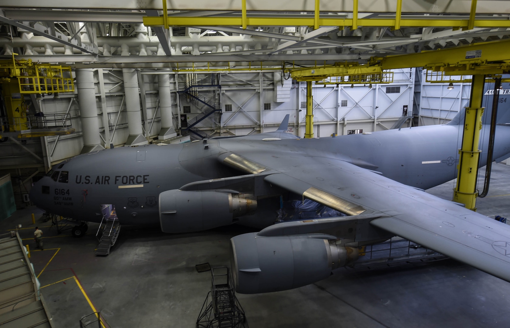 A C-17 Globemaster III from Travis Air Force Base, Calif., sits in a paint barn hangar for paint touch-ups Aug. 6, 2018, at Joint Base Lewis-McChord, Wash. California laws prevent Travis Airmen from spray-painting their C-17s, so they brought it to McChord where it is allowed. (U.S. Air Force photo by Senior Airman Tryphena Mayhugh)