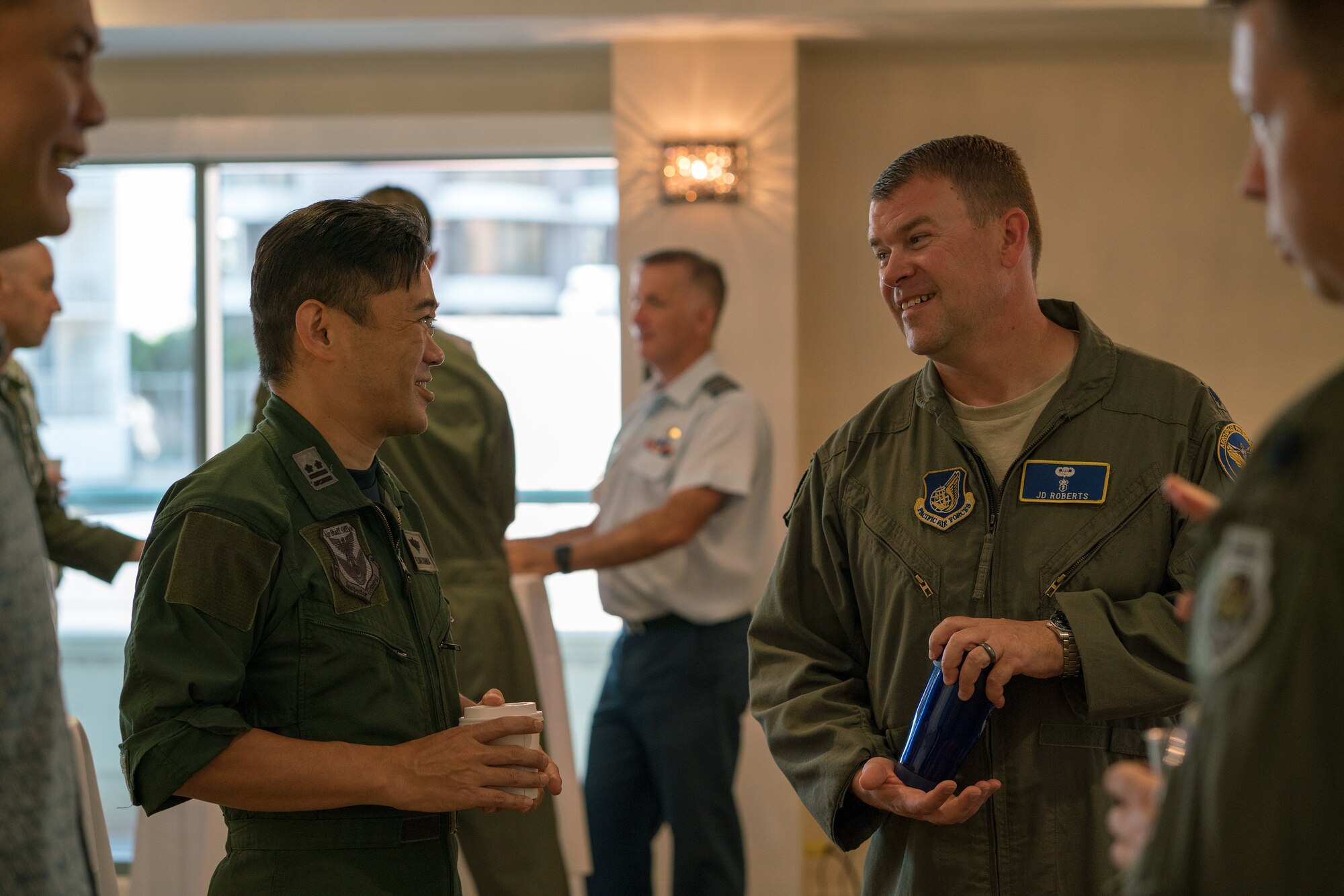 Koku Jieitai (Japan Air Self-Defense Force) Lt. Col. Ryouhei Nakashima (left) and U.S. Air Force Lt. Col. Daniel Roberts, Chief Aviation Management Branch, PACAF Human Factors (right) socialize during the Asia-Pacific Aviation Safety Subject Matter Expert Exchange (APASS) in Honolulu, Hawaii, Aug. 14, 2018. APASS allows partner nations in the Indo-Pacific to discuss aviation safety practices and devise  solutions to challenges faced by the various air forces. (U.S. Air Force photo by Staff Sgt. Daniel Robles)