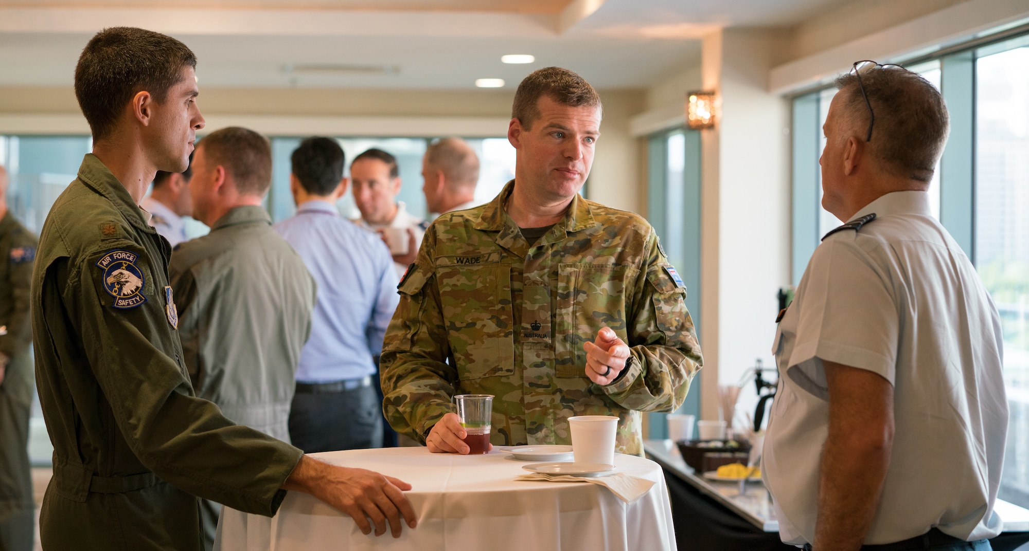 U.S. Air Force Maj. Eric Johnston (left), Royal Australian air force Maj. David Wade (center) and Royal Canadian air force Col. John Alexander (right) socialize during the Asia-Pacific Aviation Safety Subject Matter Expert Exchange (APASS) in Honolulu, Hawaii, Aug. 14, 2018. APASS allows partner nations in the Indo-Pacific to discuss aviation safety practices and devise solutions to challenges faced by the various air forces. (U.S. Air Force photo by Staff Sgt. Daniel Robles)