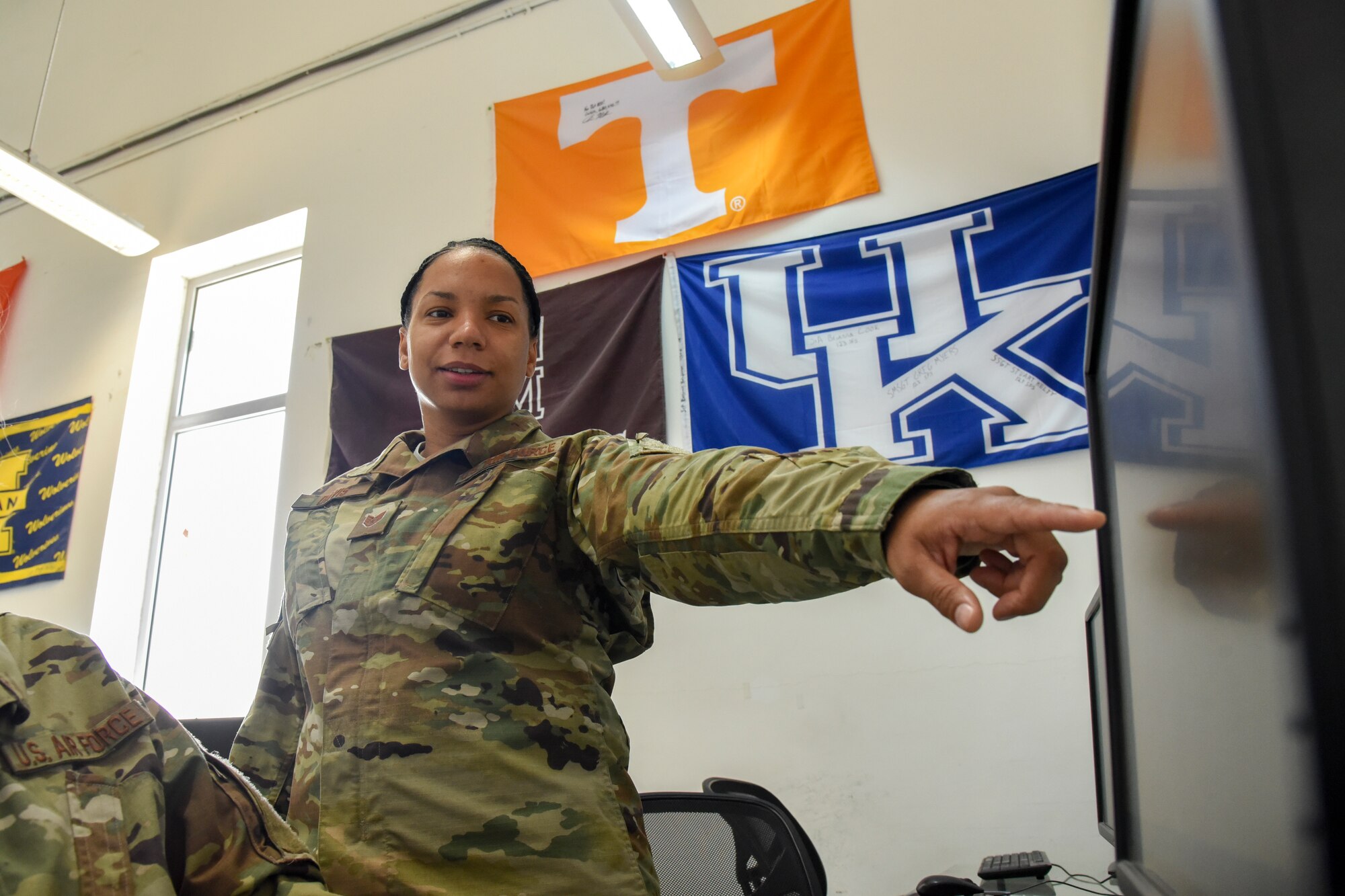 Staff Sgt. Kamika Davis explains the process of verifying military education records at Al Udeid Air Base, Qatar, July 24, 2018. Davis has been an education unit training manager for two years. (U. S. Air Force photo by Staff Sgt. Enjoli Saunders)