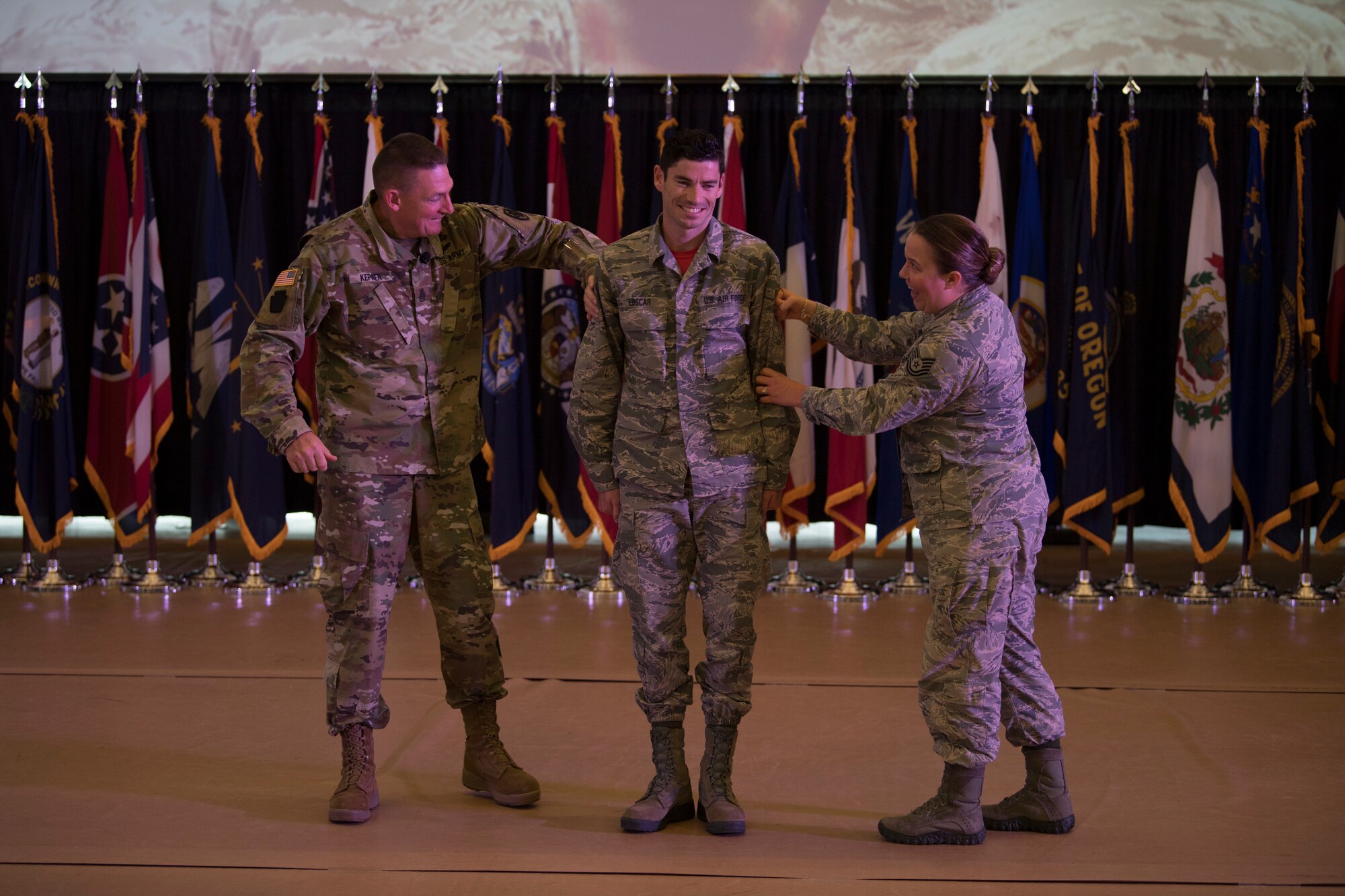 Command Sgt. Maj. Christopher Kepner, the Senior Enlisted Advisor to the Chief, National Guard Bureau, assists in the promotion an Airman at the Enlisted Leadership Symposium (ELS) August 17, 2018 at Camp Dawson, W.Va. More than 400 Airmen representing Air National Guard units from each state and territory attended the ELS, a three-day event focused on leadership and professional development. (U.S. Air National Guard Photo by Airman 1st Class Caleb Vance)