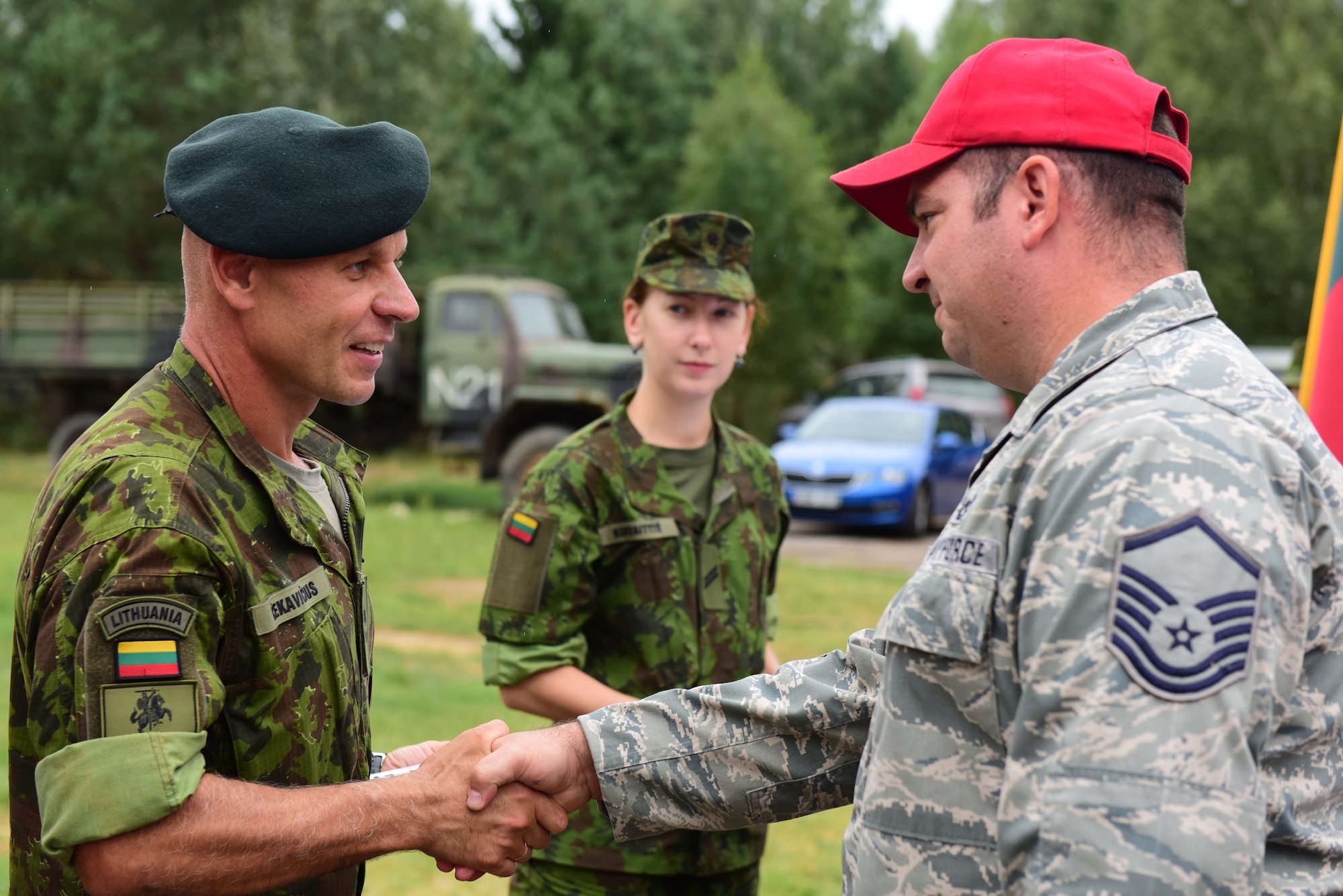 Lithuanian Maj. Kestutis Cekavicius (left), training area commander at the Brigadier General Kazio Veverskis Training Grounds, Kazlu Ruda, Lithuania, thanks U.S. Air Force Master Sgt. Andrew Hikes, 201st Rapid Engineer Deployable Heavy Operational Repair Squadron Engineers non-commissioned officer in charge of Rotation 2, during a ceremony on the rotation’s last day in Lithuania, Aug. 13, 2018. This is the second of four 201st RHS rotations traveling to Lithuania completing deployment for training and constructing a military air-to-ground training range to be used by Lithuanian and other NATO forces. (U.S. Air National Guard photo by Tech. Sgt. Claire Behney/Released)