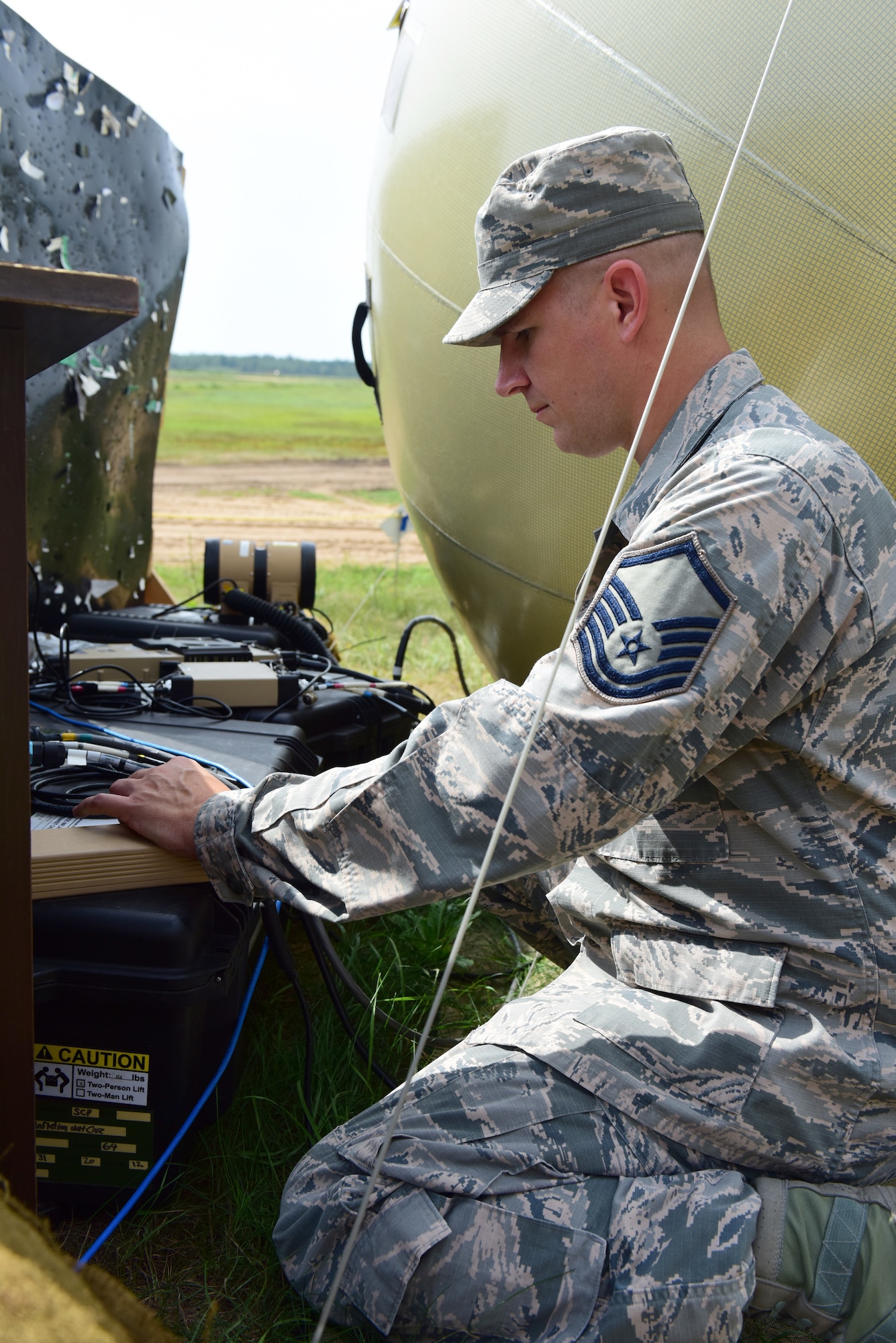 Master Sgt. Matt Throne, Radio Frequency transmissions, 271st Combat Communications Squadron, completes a preventive maintenance inspection on the satellite antenna set up on location at Brigadier General Kazio Veverskis Training Grounds, Kazlu Ruda, Lithuania, Aug. 14, 2018. Airmen of the 271st CBCS established a Small Communications Package to provide network and phone access to the teams completing deployment for training by constructing a military air-to-ground training range to be used by Lithuanian and other NATO forces. (U.S. Air National Guard photo by Tech. Sgt. Claire Behney/Released)