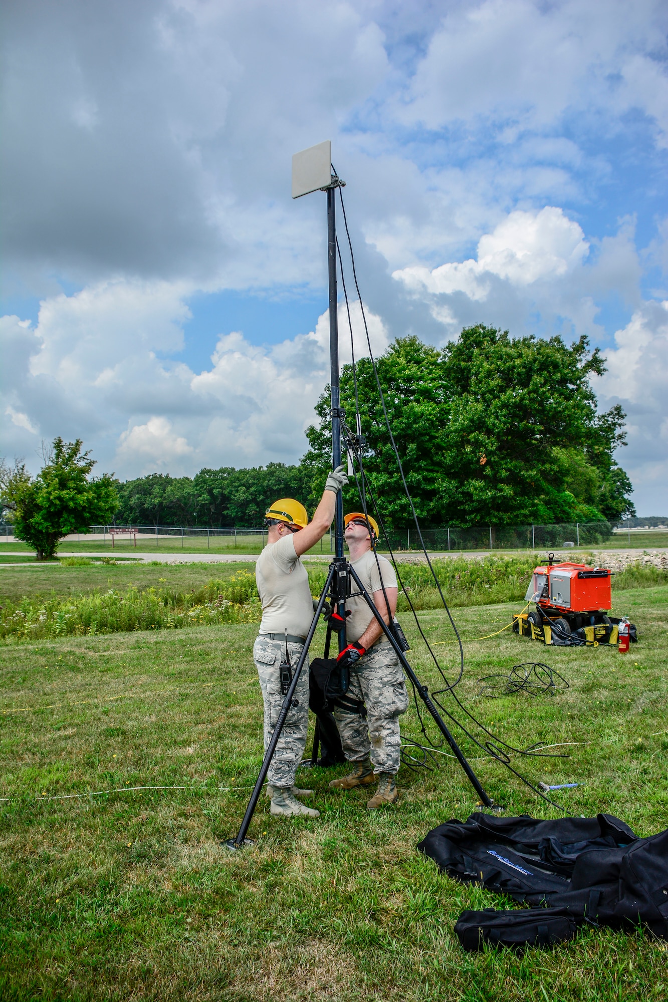 Staff Sgt. Nickolas Dykstra and Staff Sgt. Ryan Malecki, Joint Incident Site Communications Capability operators with the 115th Fighter Wing work together to set up a wireless internet antennae mast for the Wisconsin Chemical, Biological, Radiological, Nuclear and High Yield Explosive Enhanced Response Force Package External Evaluation exercise at Volk Field Air National Guard Base, Aug. 16, 2018. The ExEval is conducted as a way to re-validate the WI CERFP to perform its CBRN Response Enterprise mission in support of the State and Nation.(U.S. Air National Guard photo by Tech. Sgt. Mary E. Greenwood)