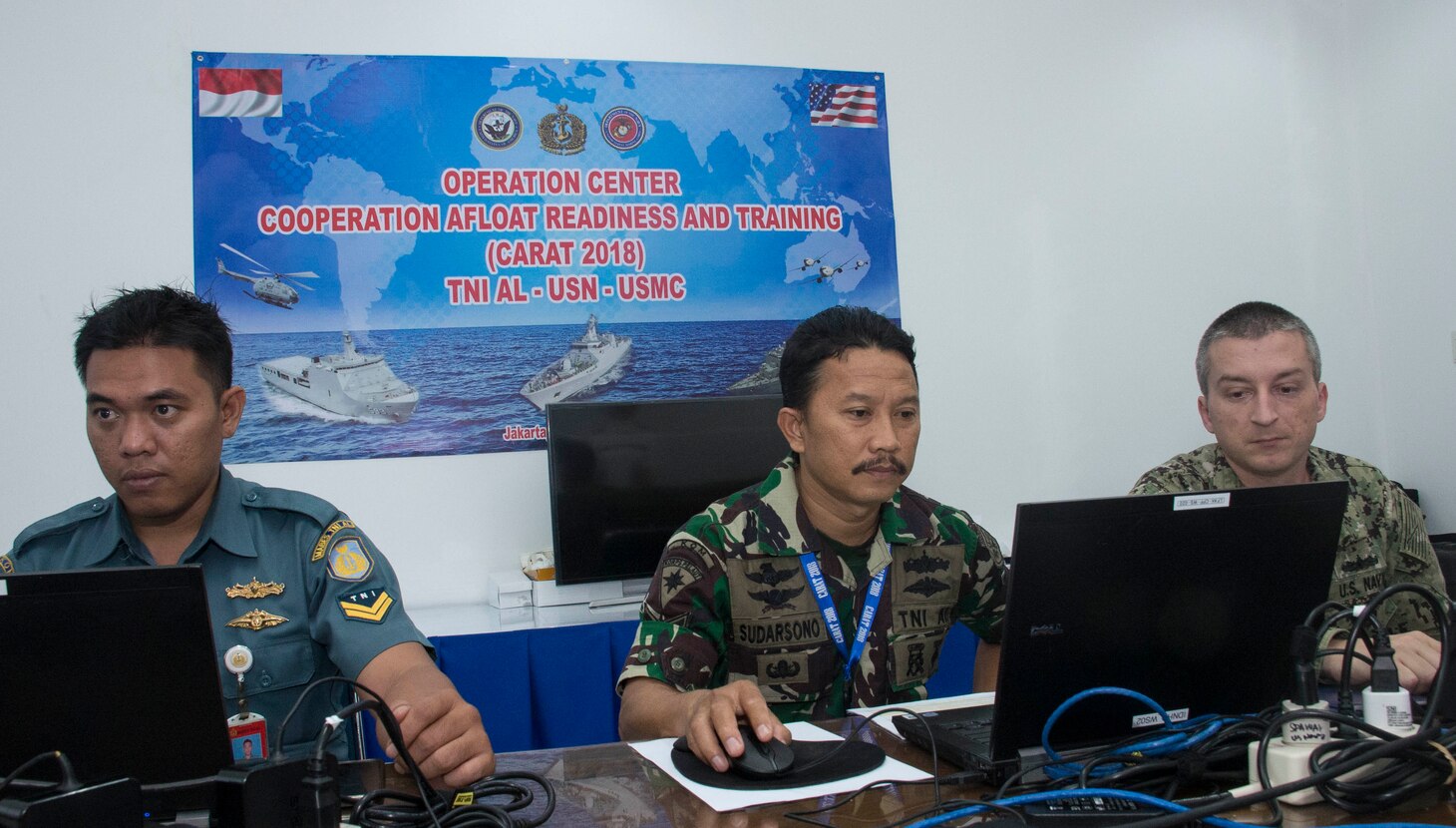 Petty Officer 2nd Class Herman Syah (left), and Petty Officer 1st Class Sudarsano, (middle), of the Indonesian Navy, and Electronics Techinician 2nd Class Andrew Slabaugh, aasigned to Commander, Task Force 73 (CTF73), work together as part of Combined Enterprise Regional Exchange (CENTRIX), at 1st Fleet Training Command, in Jakarta, Indonesia, during Cooperation Afloat Readiness (CARAT), Indonesia. CARAT Indonesia, in its 24th iteration, is designed to enhance information sharing and coordination, build mutual warfighting capability and support long-term regional cooperation enabling both partner armed forces to operate effectively together as a unified maritime force.
