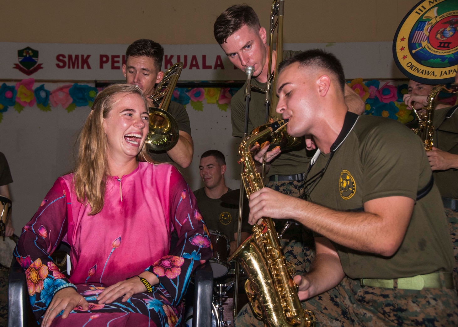 KUALA PENYU, Malaysia (August 13, 2018) - Lance Cpl. Alex Ilgenfrtiz performs for an audience member with the III Marine Expeditionary Force Band during a show at SMK Pekan Kuala Penyu Primary School in Kuala Penyu, Malaysia in support of Cooperation Afloat Readiness and Training (CARAT) 2018. Communication Specialist 3rd Class Christopher A. Veloicaza)