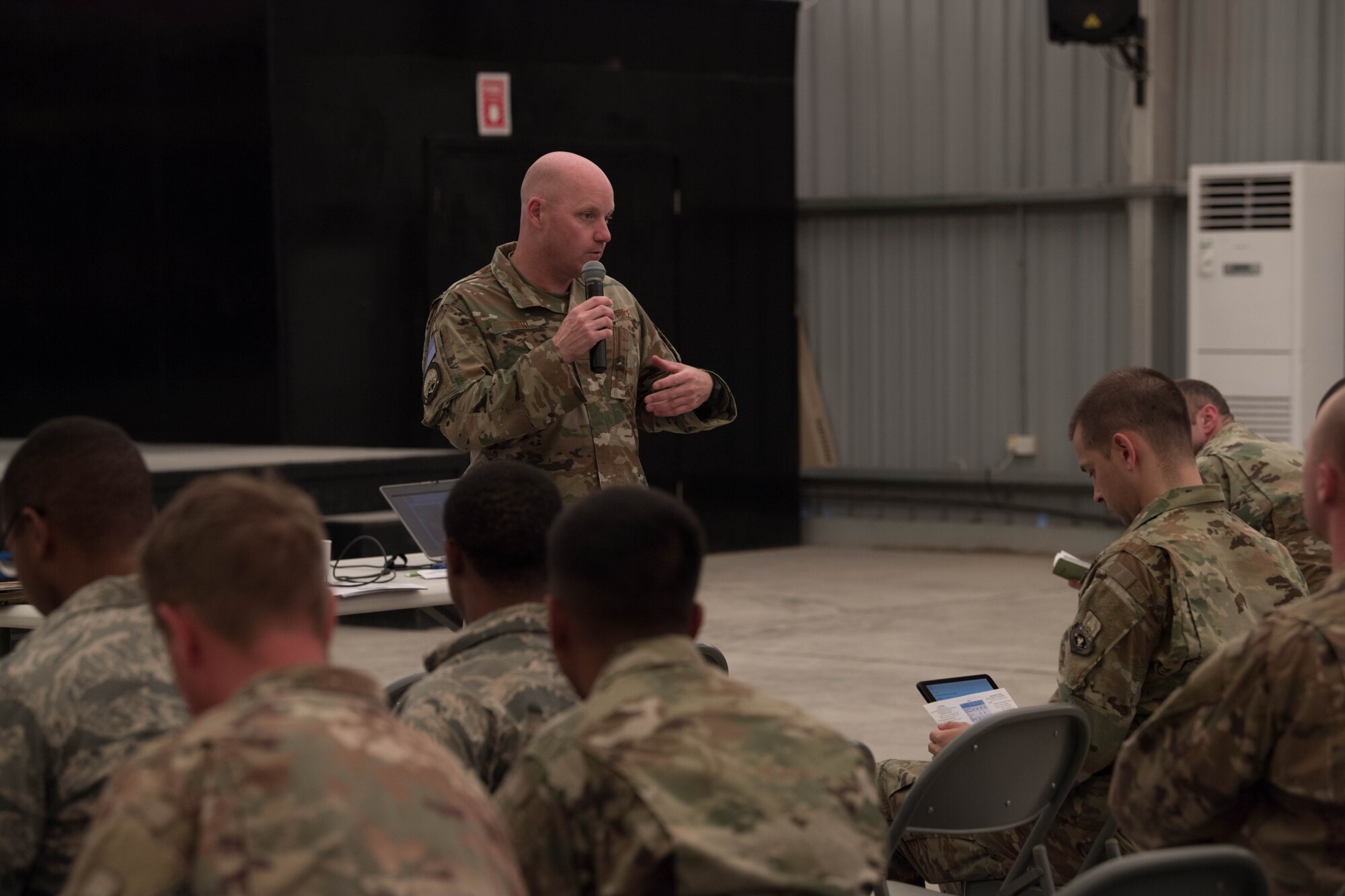 Col. Cory Reid, Senior Air Reserve Component advisor, speaks to Air Reserve and Air National Guard members at a town hall meeting on Al Dhafra Air Base, Aug. 9, 2018.  Reid, along with Lt. Col. Andrew Frankel, Deputy Air Reserve Component advisor, visited Reserve and Guard members in the 380th Air Expeditionary Wing to inform them on their entitled benefits and address any concerns members may have while deployed. (U.S. Air Force photo by Staff Sgt. Erica Rodriguez)
