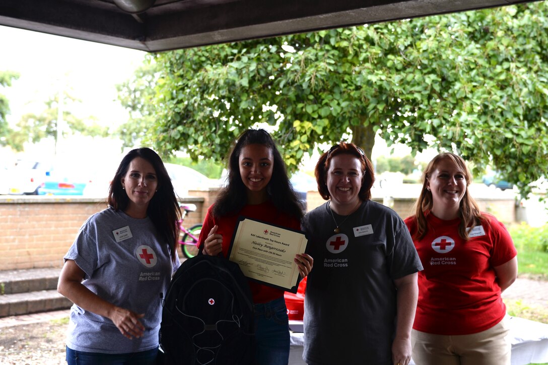 Hailey Bangerezako, a Red Cross volunteer, receives an award at the Summer Youth Program’s end of summer barbeque, Royal Air Force Lakenheath, England, Aug. 17 2018. Bangerezako attained the most volunteer hours on the installation. (U.S. Air Force photo/Airman 1st Class Shanice Williams-Jones)
