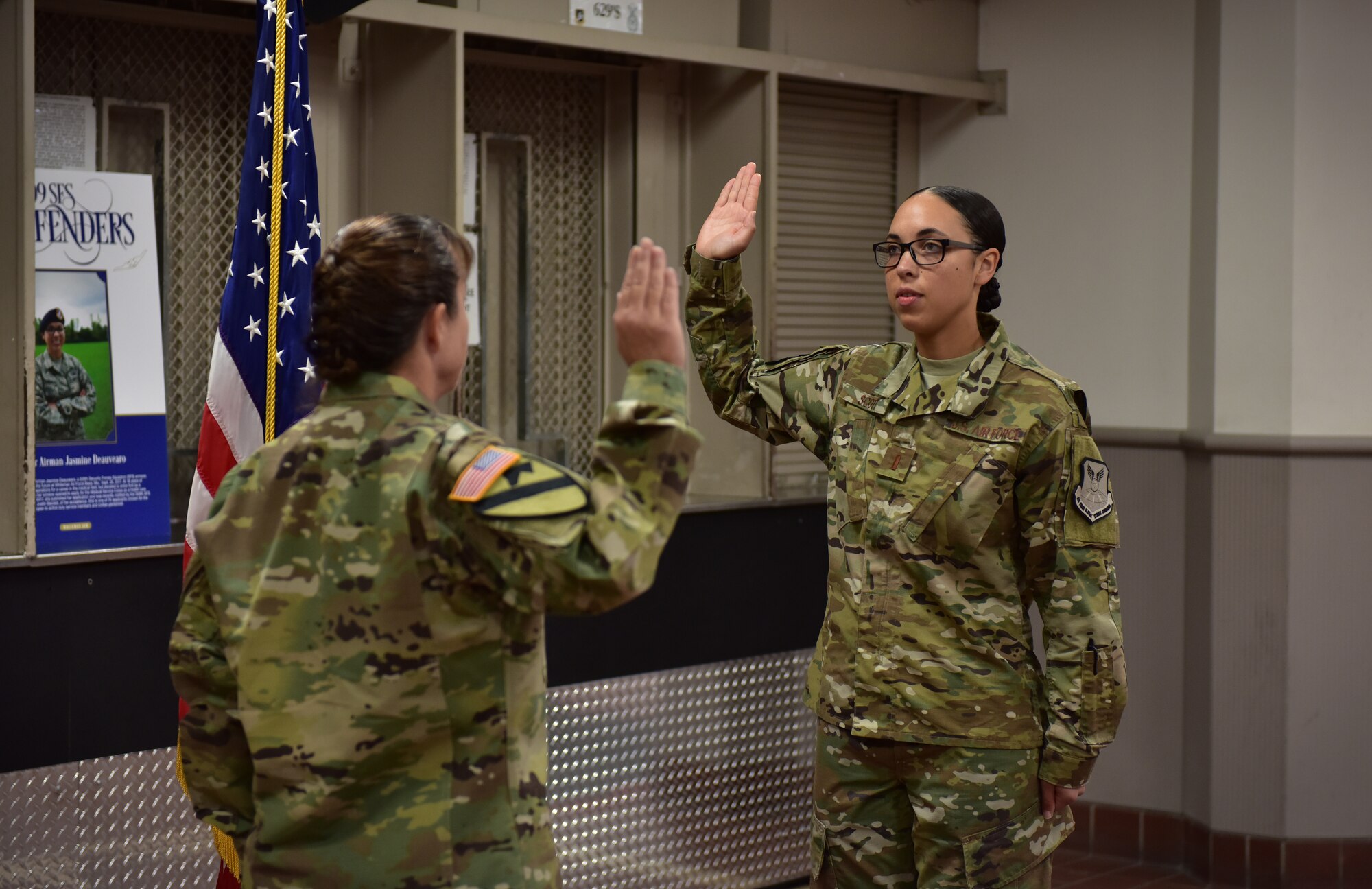 U.S. Army Maj. Darla Deauvearo, left, administers the oath of office to her daughter 2nd Lt. Jasmine Scott, Aug. 10, 2018, at Whiteman Air Force Base. Scott was a member of the 509th Bomb Wing and commissioned into the medical services field.  (U.S. Air Force photo by Tech. Sgt. Alexander W. Riedel)