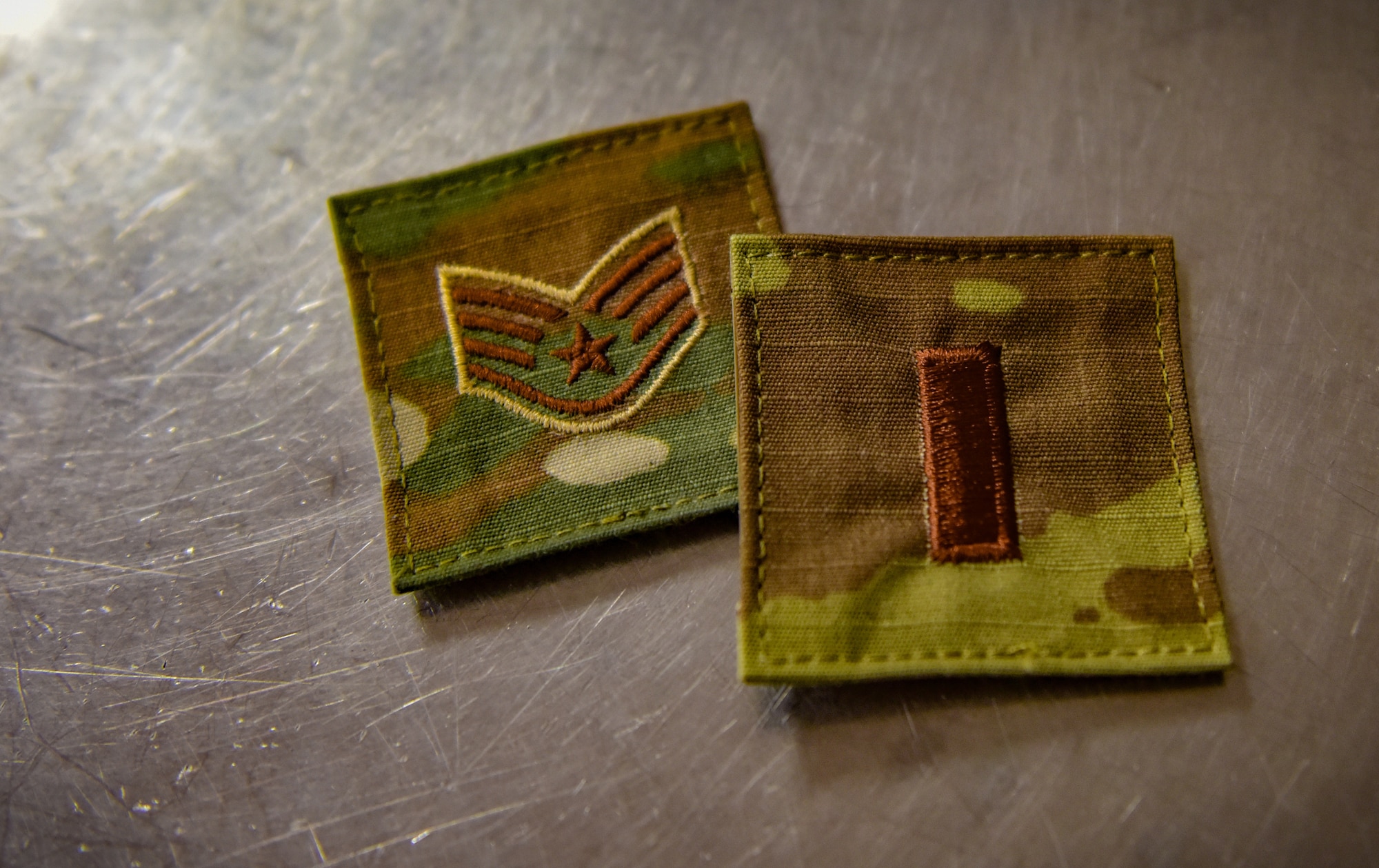 Two rank patches worn on the same day by 2nd Lt. Jasmine Scott, Aug. 10, 2018, at Whiteman Air Force Base, Mo. Scott commissioned into the medical services corps, after serving as an enlisted armorer at the 509th Security Forces Squadron. (U.S. Air Force photo by Tech. Sgt. Alexander W. Riedel)