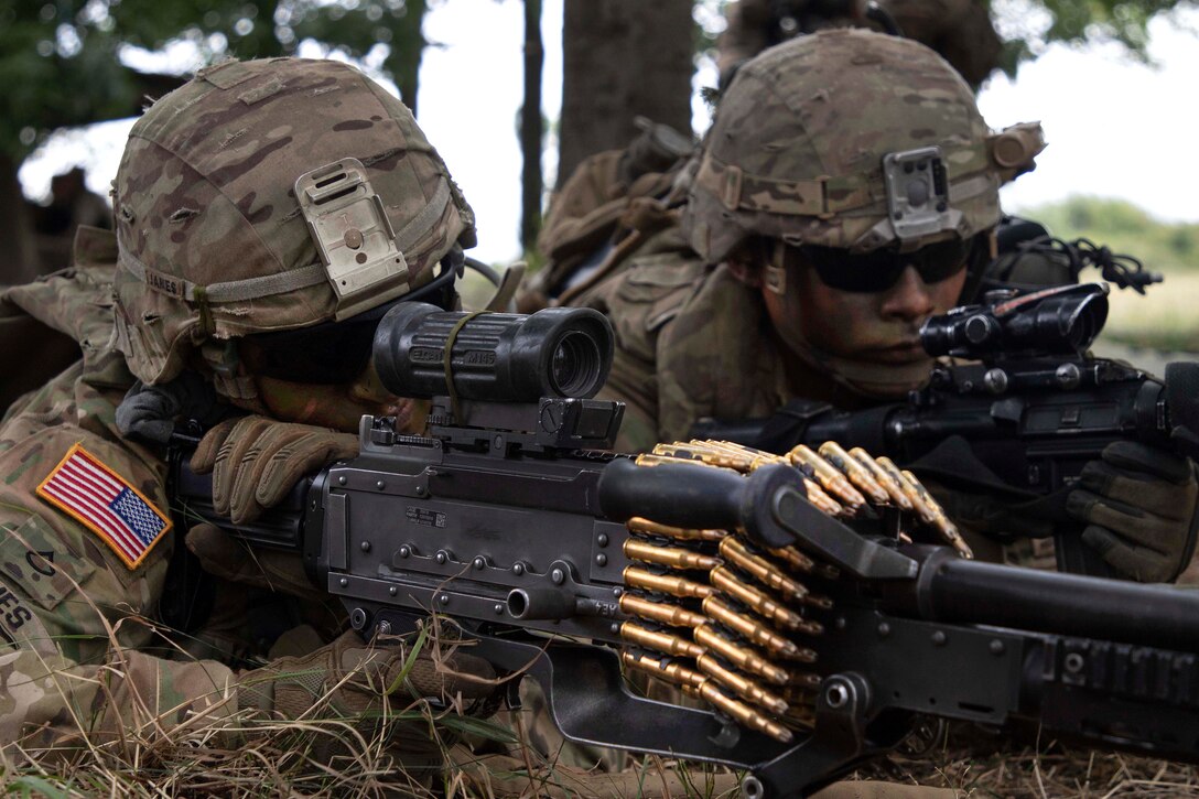 Soldiers scan their sectors while providing security during an air assault training exercise.