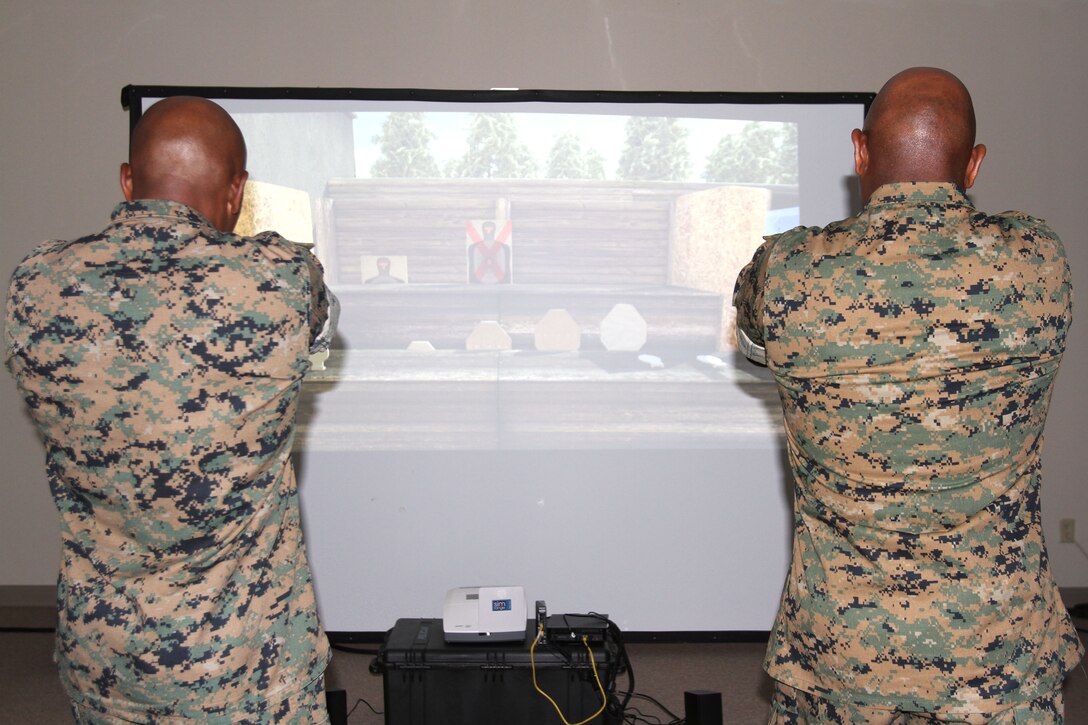 Marine Corps Logistics Base Albany Commanding Officer Col. Alphonso Trimble (right) and Sgt. Maj. Johnny Higdon (left) test out an active shooter simulator aboard Marine Corps Logistics Base Albany, August 8. Marine Corps Police Department recently purchased the simulator to test officers's ability to make decisions during intense situations. It also prepares officers for real-life scenarios such as traffic stops and active shooter events. (U.S. Marine Corps photo by Re-Essa Buckels)
