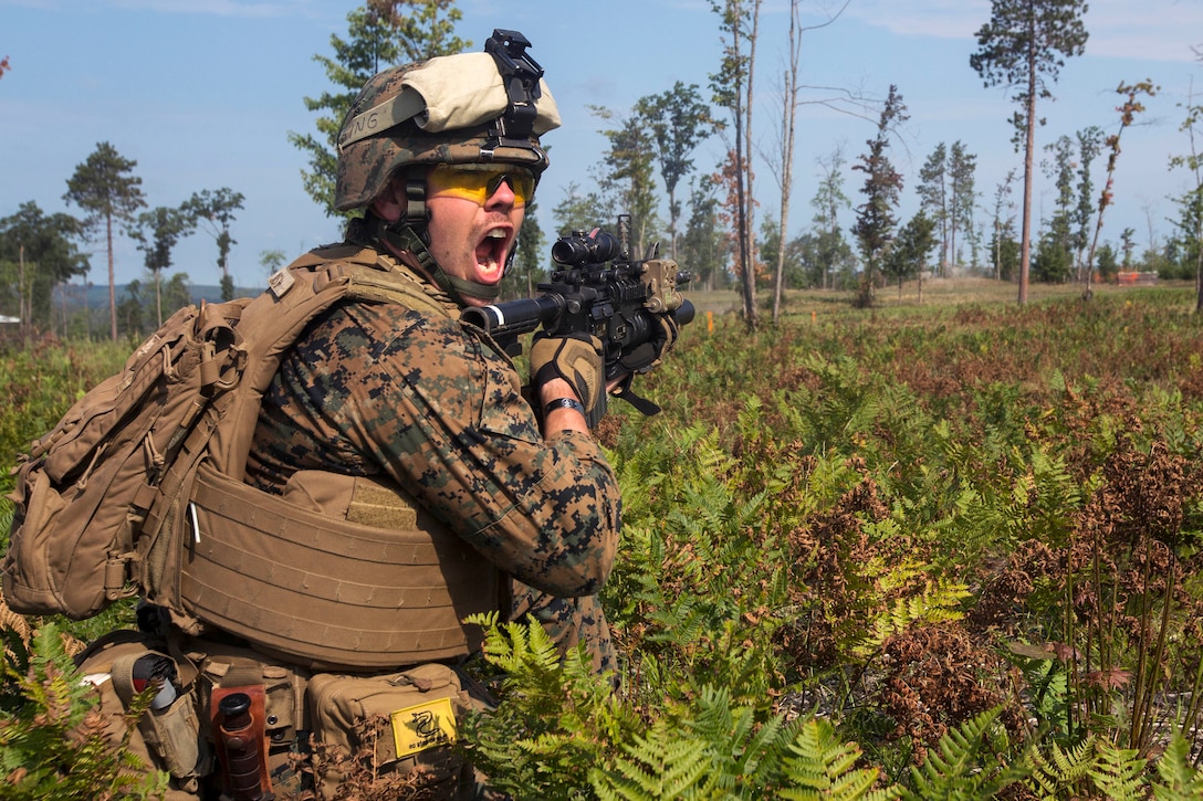 A Marine provides orders to his team during a live-fire exercise.