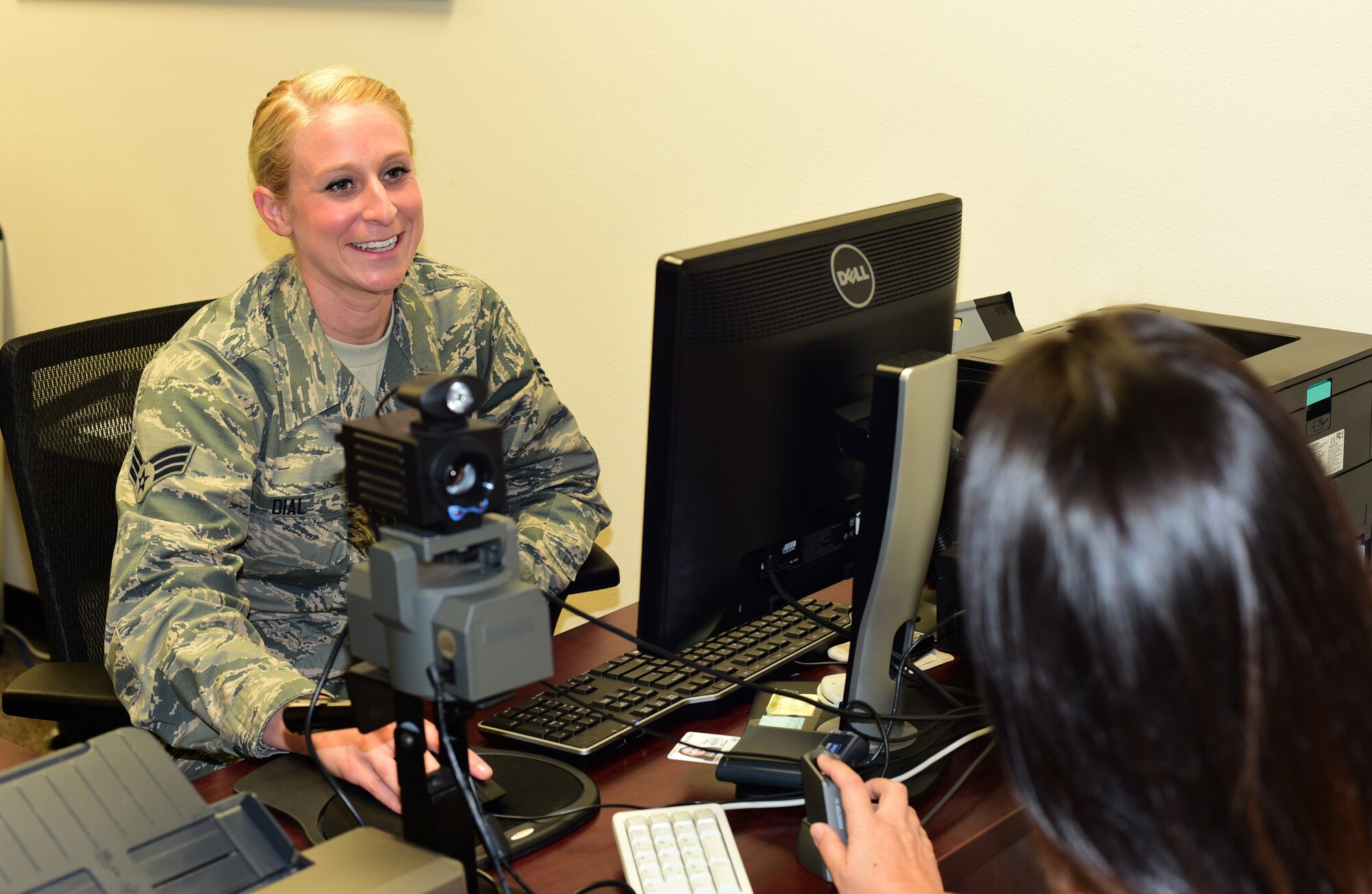 U.S. Air Force Senior Airman June Dial, 44th Fighter Group personnel specialist, assists a customer with making a new common access card, August 14, 2018, at Tyndall Air Force Base, Florida. As part of the 44th FG, Dial is part of a larger mission of training and projecting unrivaled 5th-generation combat airpower through mission ready Citizen Airmen. Though traditionally a reservist, she and her fellow 44th FG Airmen work side-by-side with active-duty Airmen to provide world class support of missions and increase the Air Force’s readiness. (U.S. Air Force photo by Senior Airman Cody R. Miller)